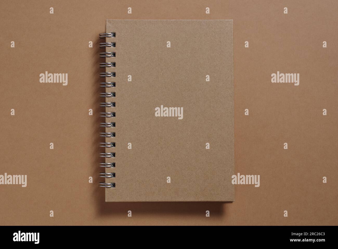 Brown notebook with spiral close-up, top view Stock Photo