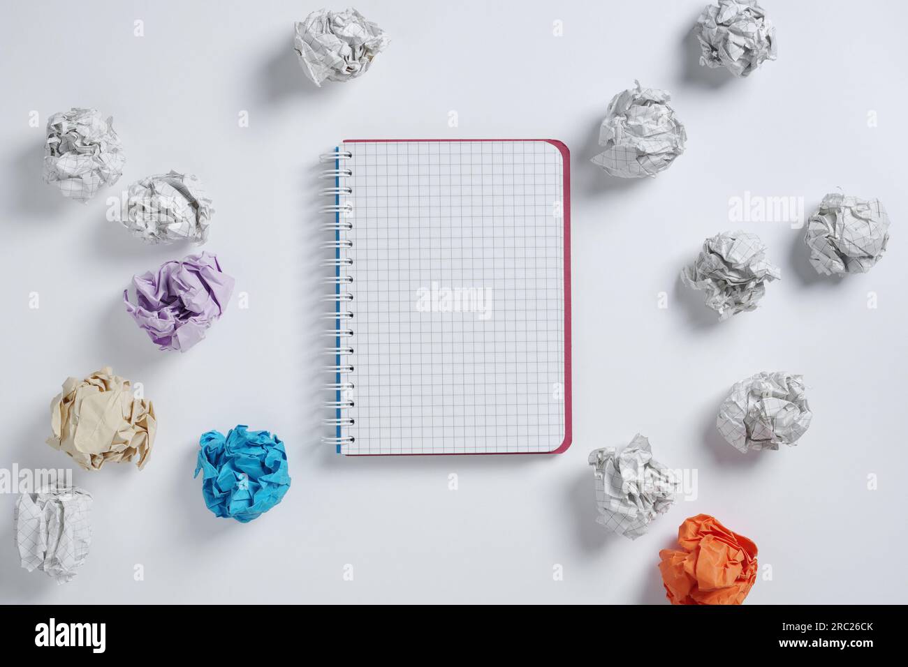 Notebook and paper balls on white background, top view Stock Photo