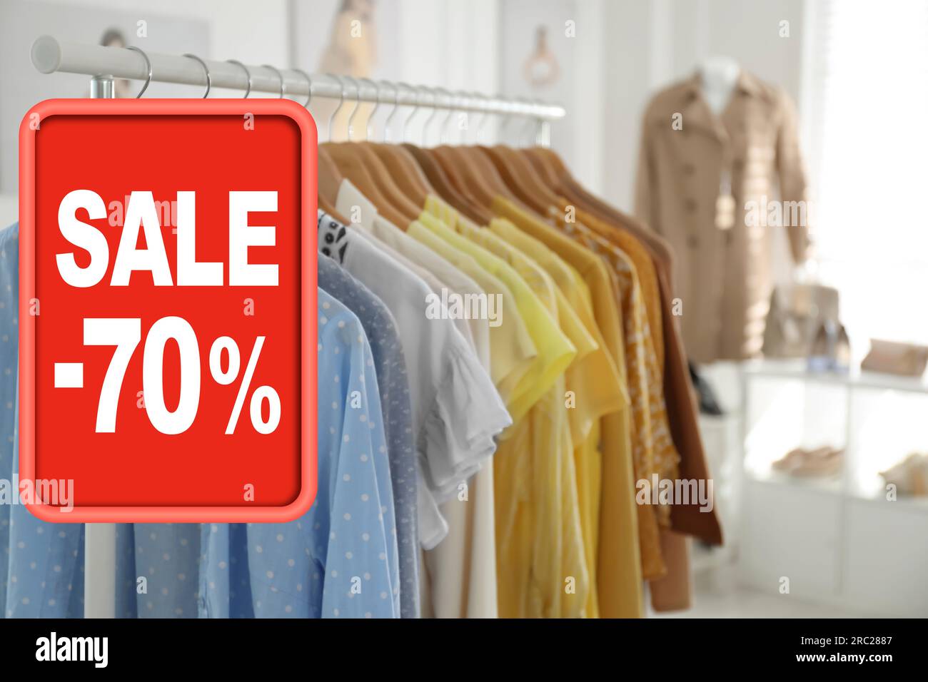 Sale In A Clothing Store - Discount Sign At A Clothes Rack Stock