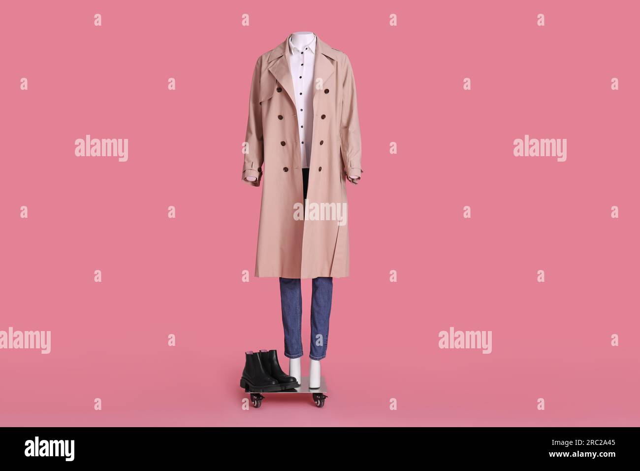 Female mannequin with boots dressed in stretch coat, jeans and shirt on