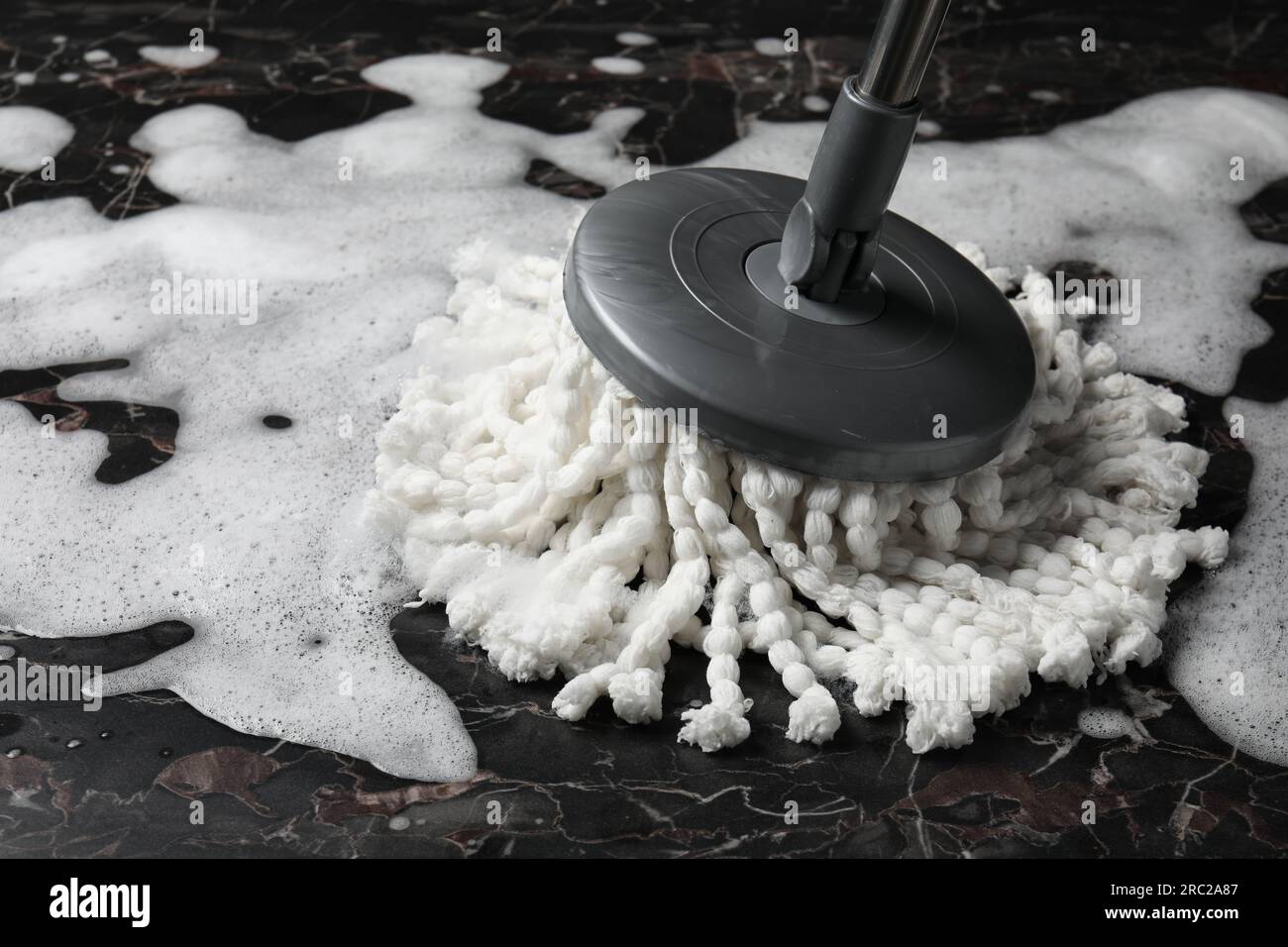 Cleaning black marble floor with string mop, closeup Stock Photo Alamy