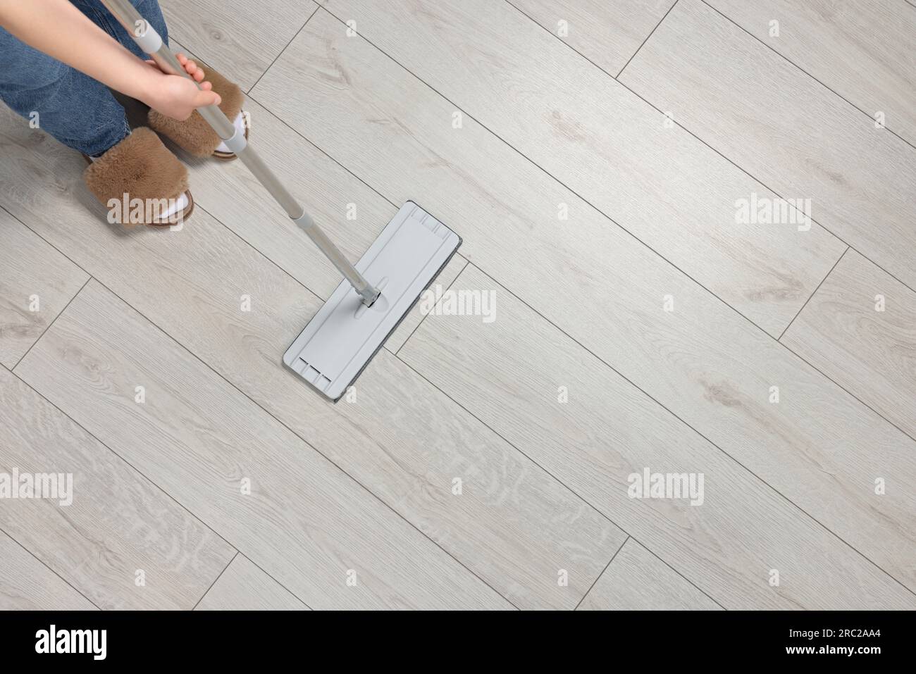 Woman mopping wooden floor, top view. Space for text Stock Photo Alamy