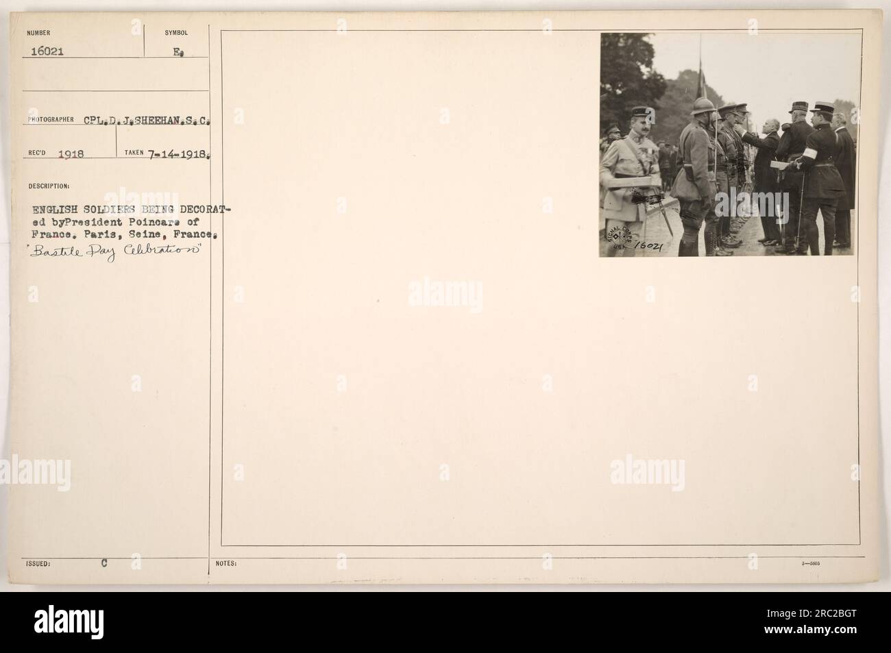 English soldiers being decorated by President Poincare of France during the 'Bastile Pay Celebration' in Paris, Seine, France. Photographed by CPL. D. J. Sheehan of S.C. ECO in 1918. This image is numbered 16021 with the symbol B. It was taken on July 14, 1918, and there are notes mentioning 76024. Stock Photo