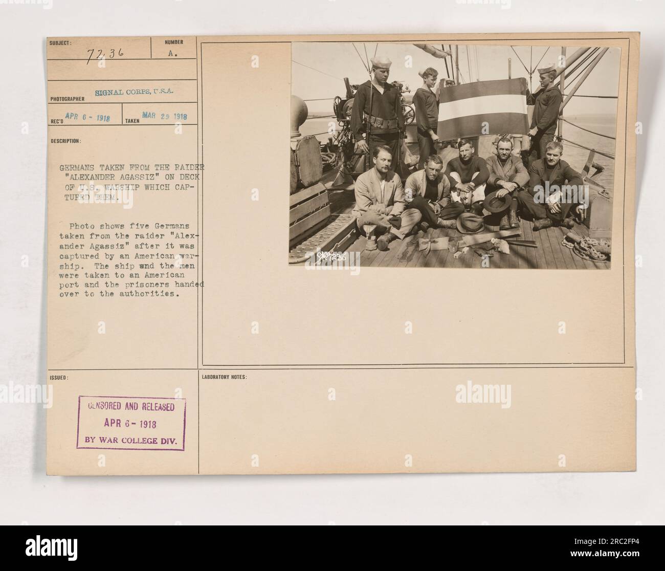 Prisoners captured from the German raider 'Alexander Agassiz' being held on the deck of a US warship. They were handed over to American authorities after the ship's capture and taken to an American port. Censored and released by the War College Division Laboratory on April 6, 1918. [Notes: 37236] Stock Photo