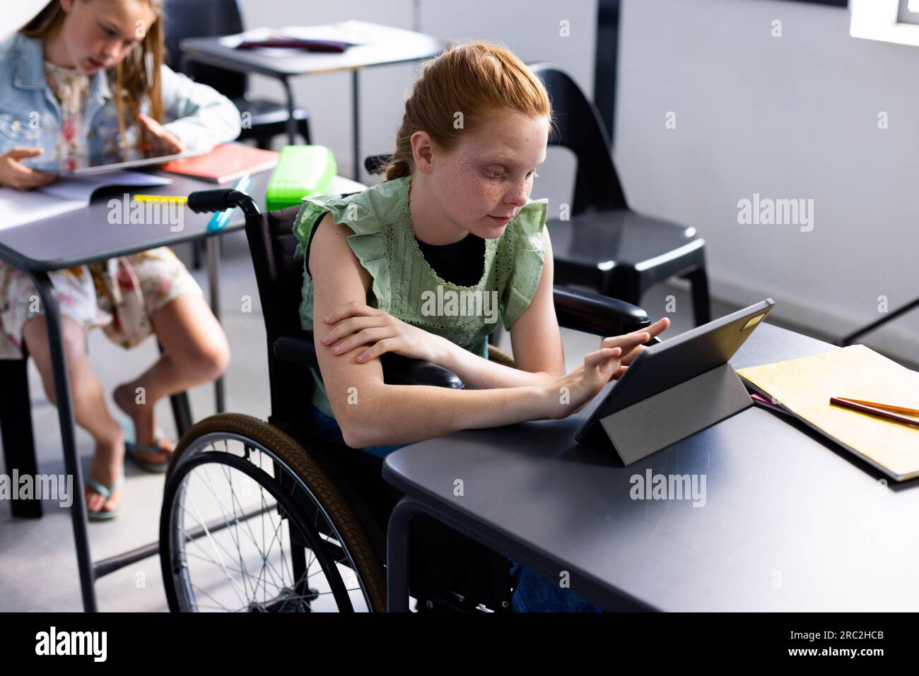 Caucasian schoolgirl in wheelchair with diverse schoolchildren in ...