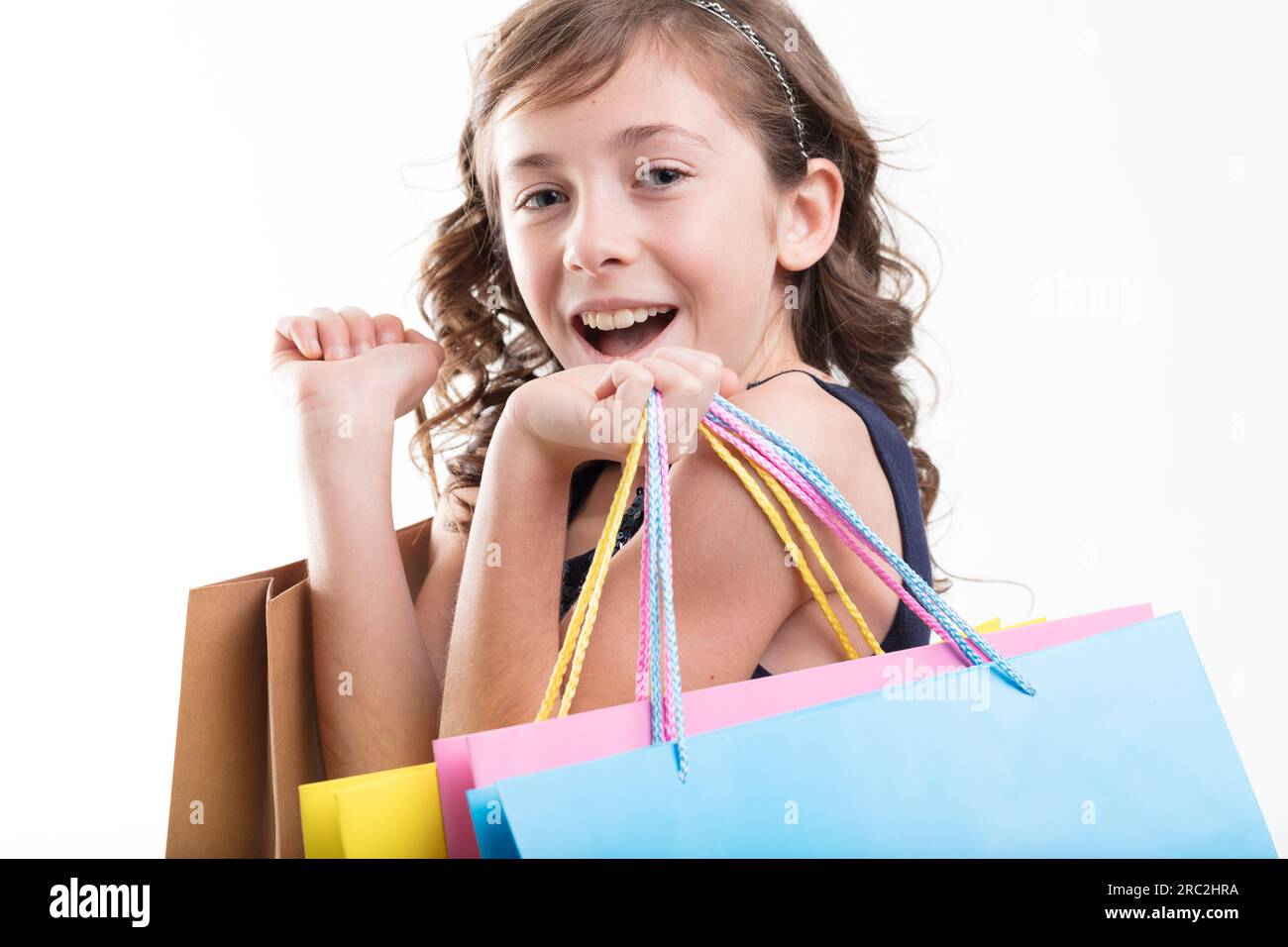 oyful girl with colorful shopping bags indulges in the thrill of spending Stock Photo