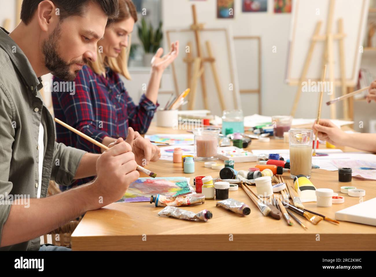 Students attending painting class in studio. Creative hobby Stock Photo