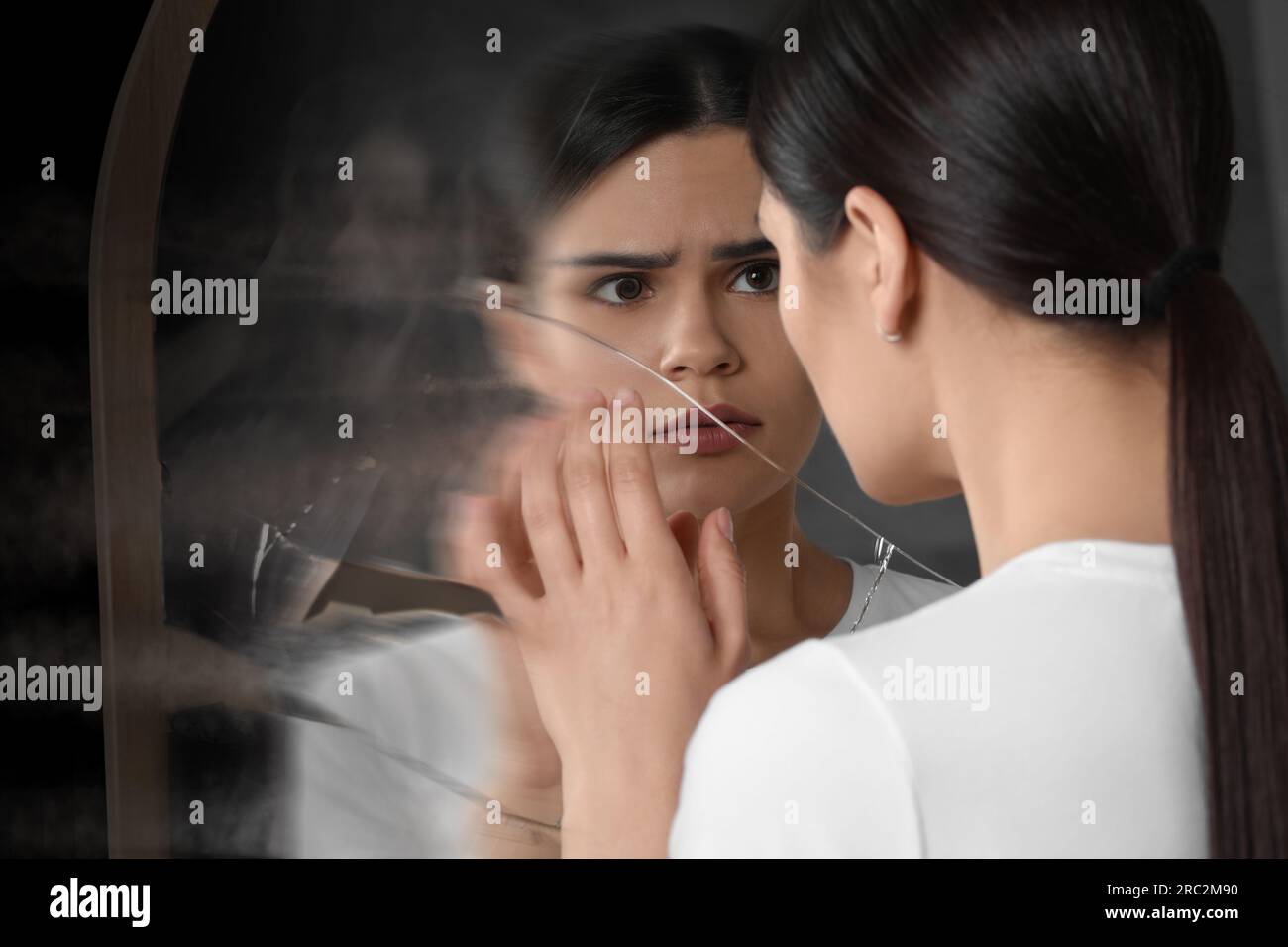 Suffering from hallucinations. Woman seeing her reflection screaming in