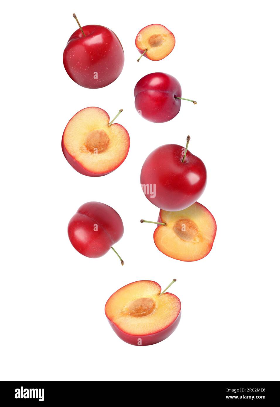 Delicious ripe cherry plums falling isolated on white Stock Photo Alamy