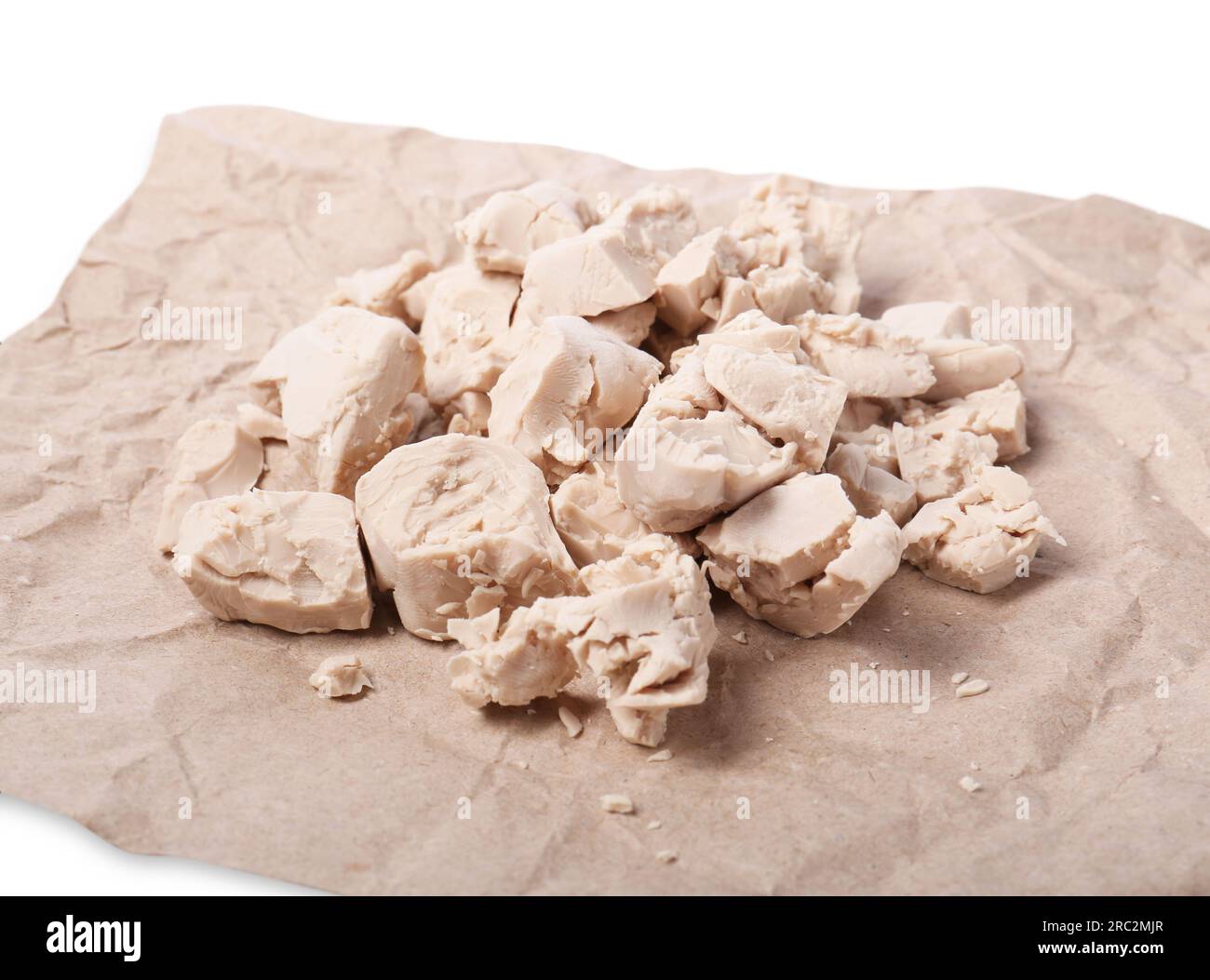 Pieces of compressed yeast on parchment paper, closeup Stock Photo Alamy