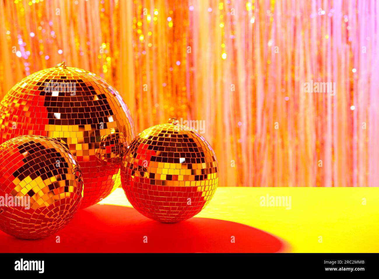 Shiny disco balls on blurred background, color toned. Space for text