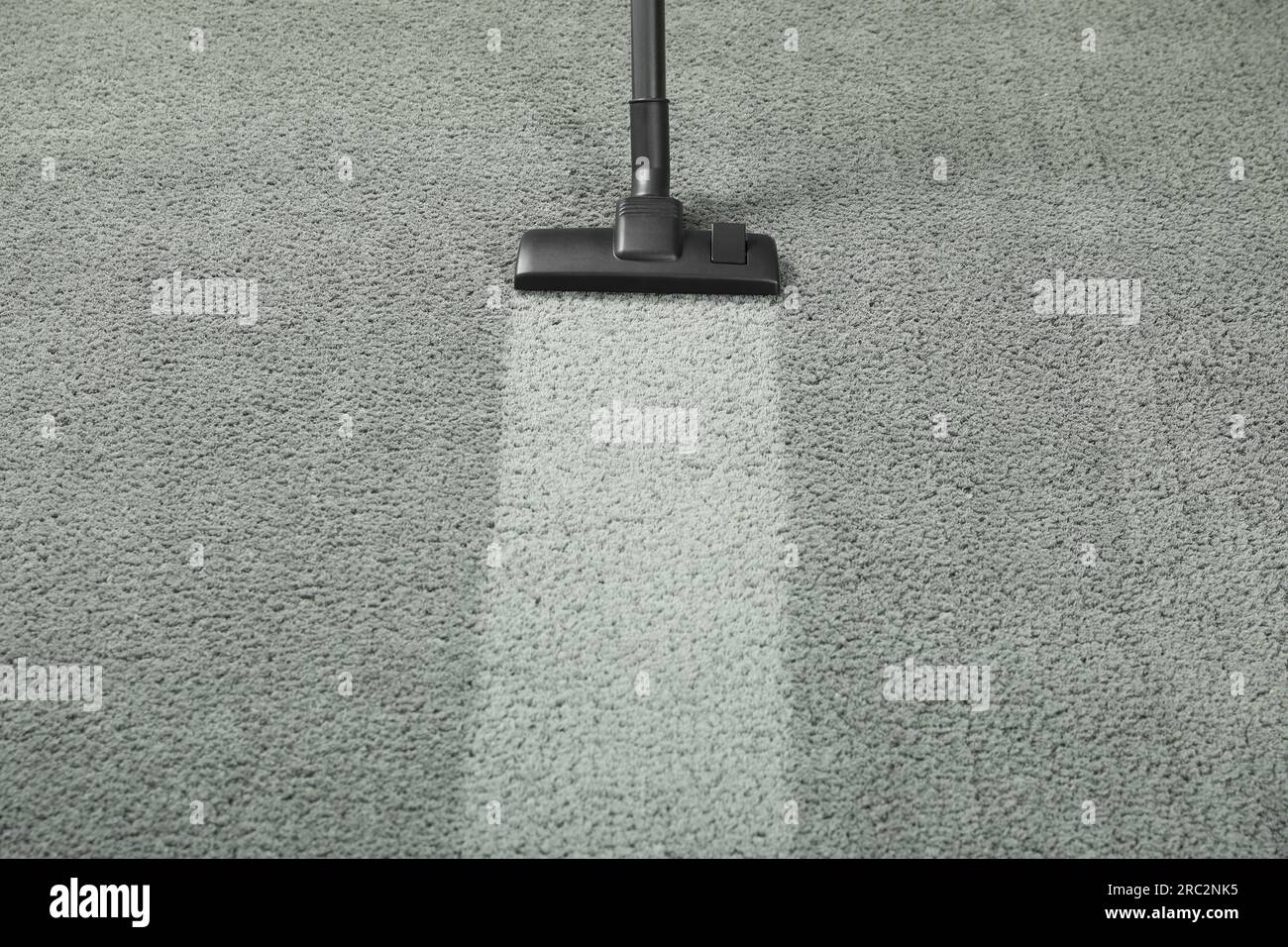 Vacuuming grey carpet. Clean area after using device. Space for text Stock Photo