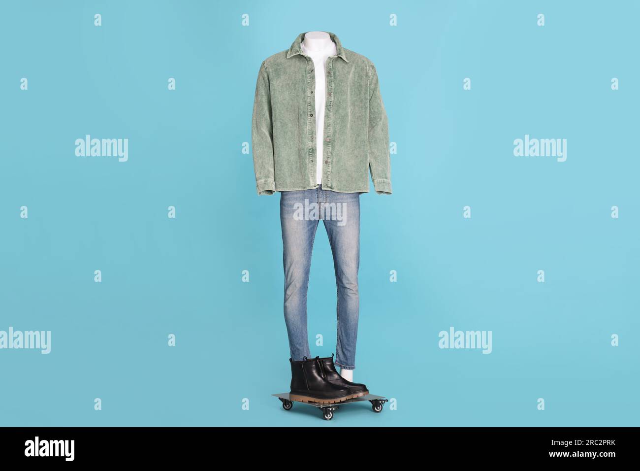 Male mannequin with boots dressed in white tshirt, jeans and stylish