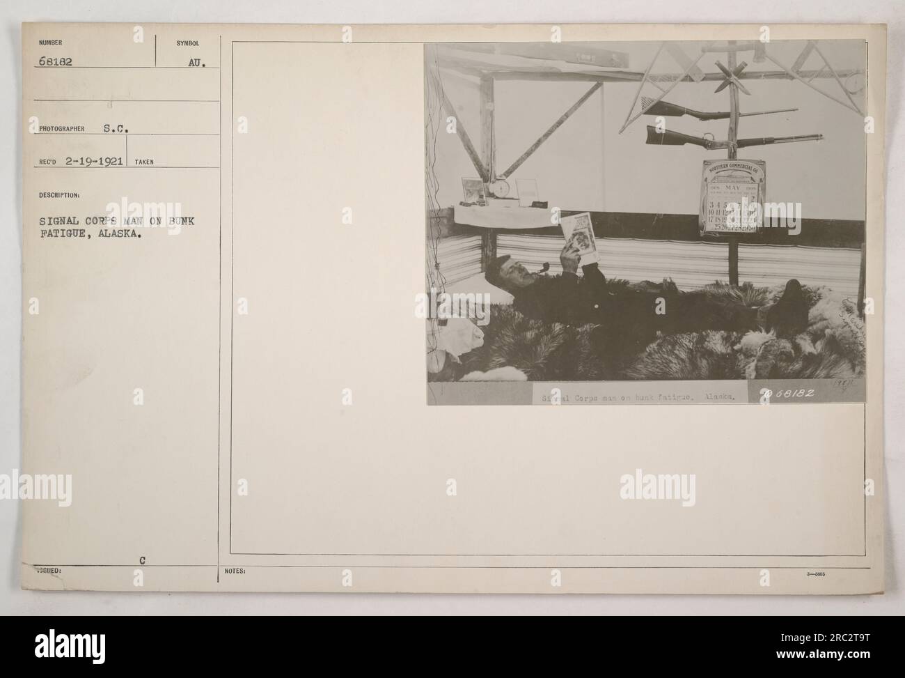Signal Corps soldier taking a moment to rest on his bunk during fatigue