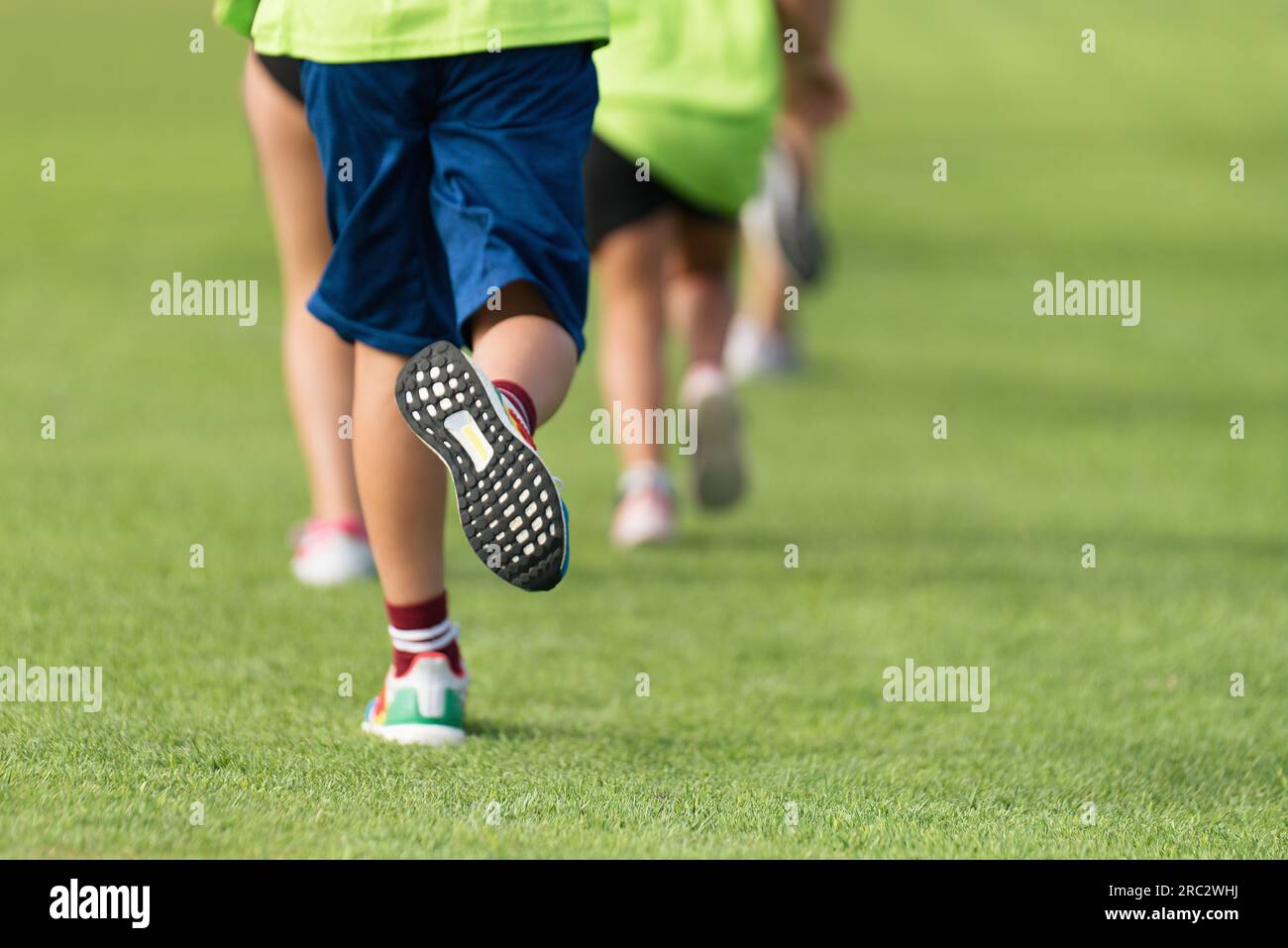 Running children, young athletes run in a kids run race, running on