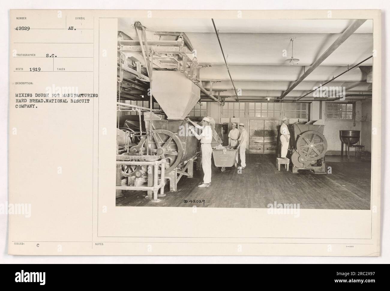 Soldiers at the National Biscuit Company during the National Biscuit Company, mixing dough to manufacture hard bread during World War I in 1919. Stock Photo