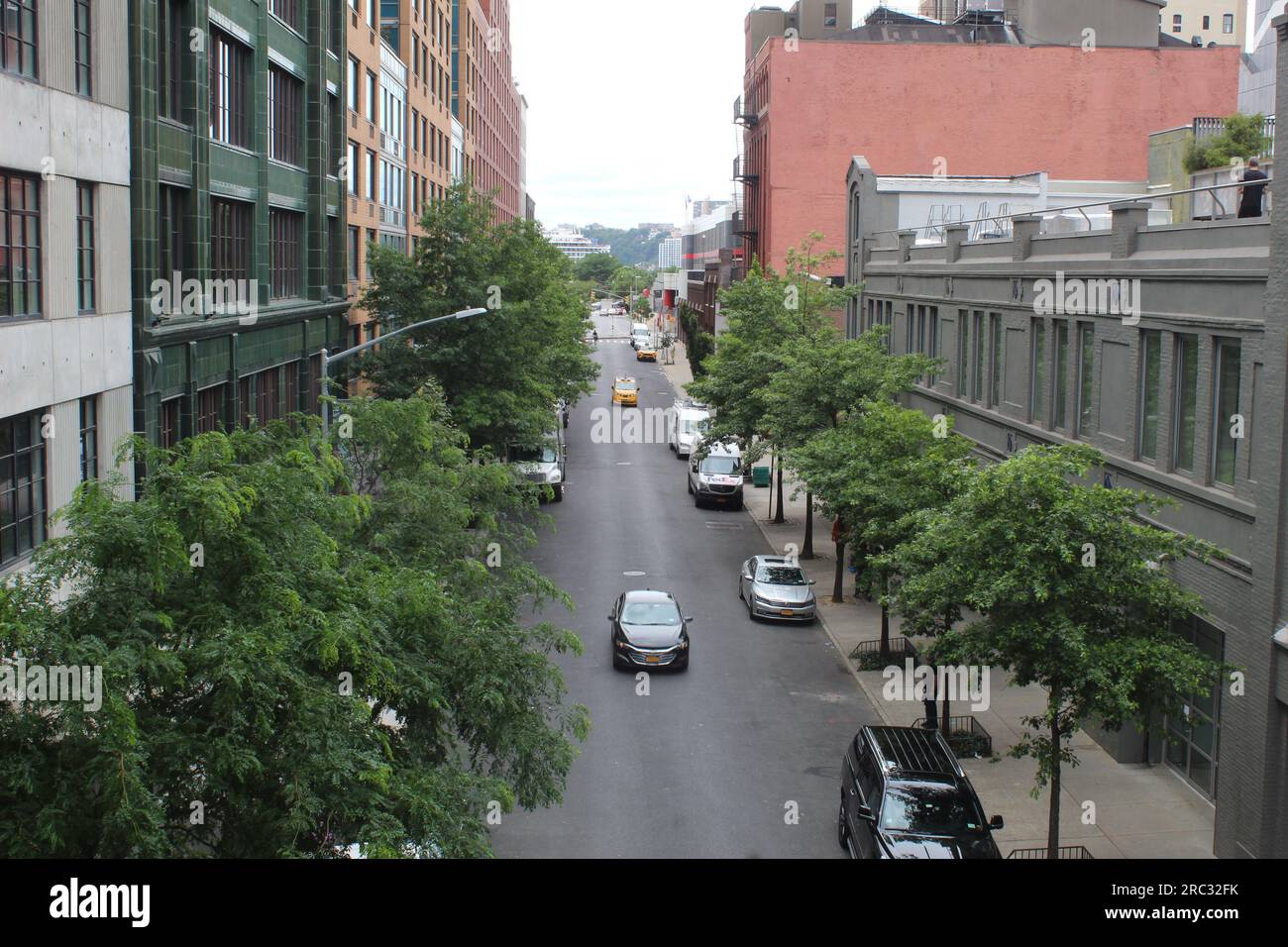 A photo of an urban street in New York City with many cars and ...