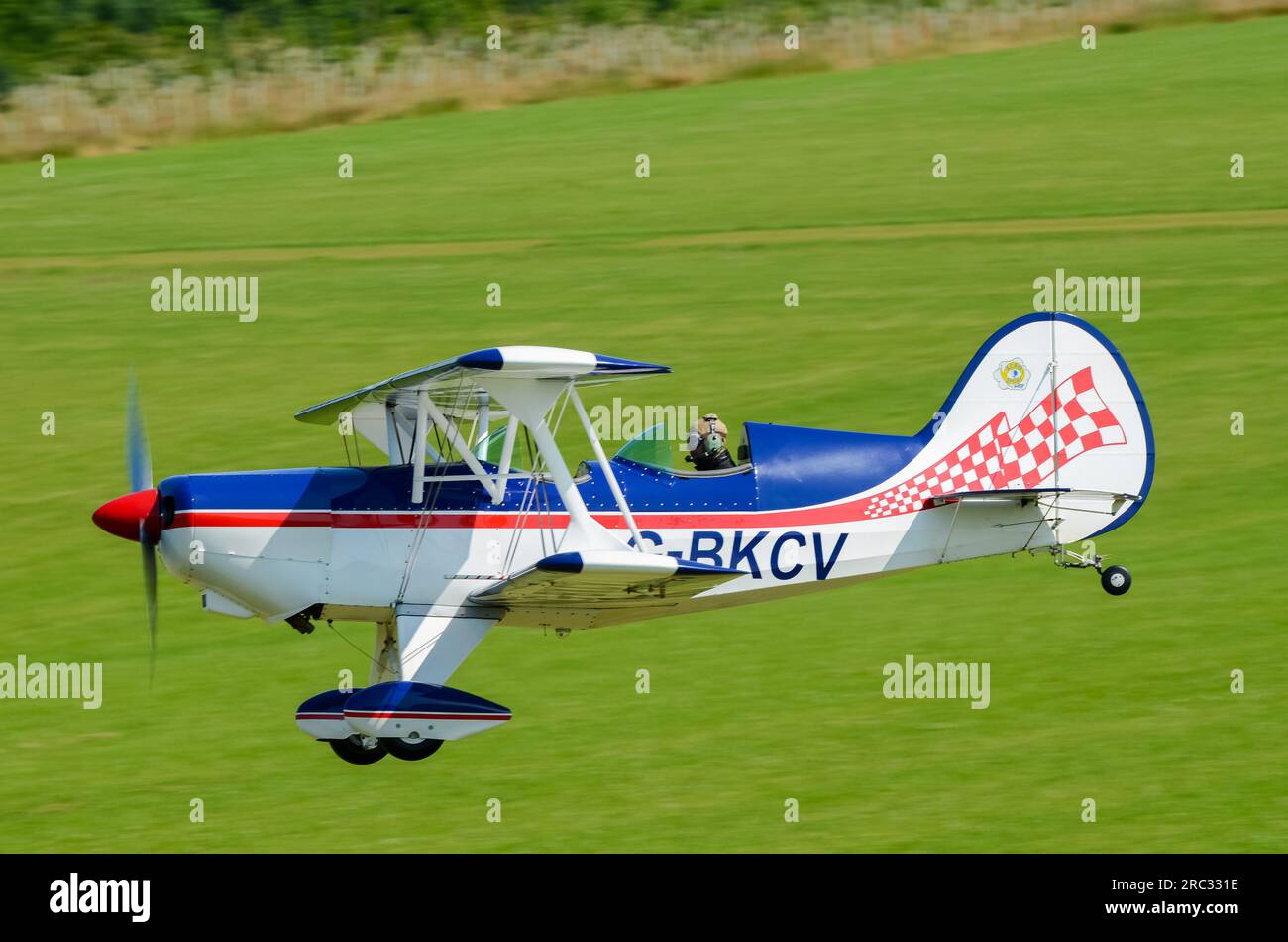 EAA Acro Sport II plane G-BKCV taking off from grass airstrip at a fly-in  event in the countryside at Heveningham Hall. Rural country in Suffolk  Stock Photo - Alamy