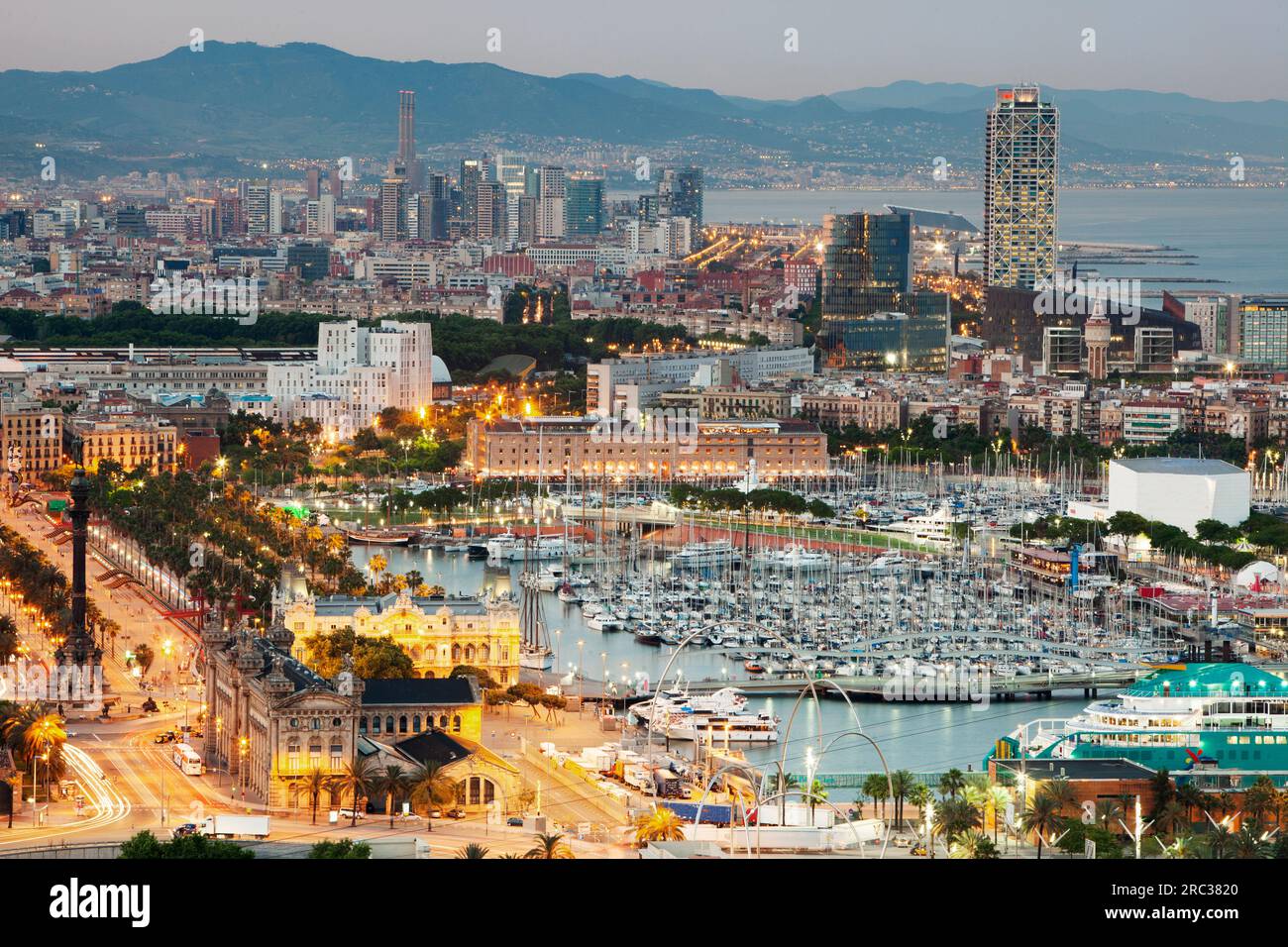 Aerial view of the skyline of Barcelona illuminated at dusk Stock Photo ...