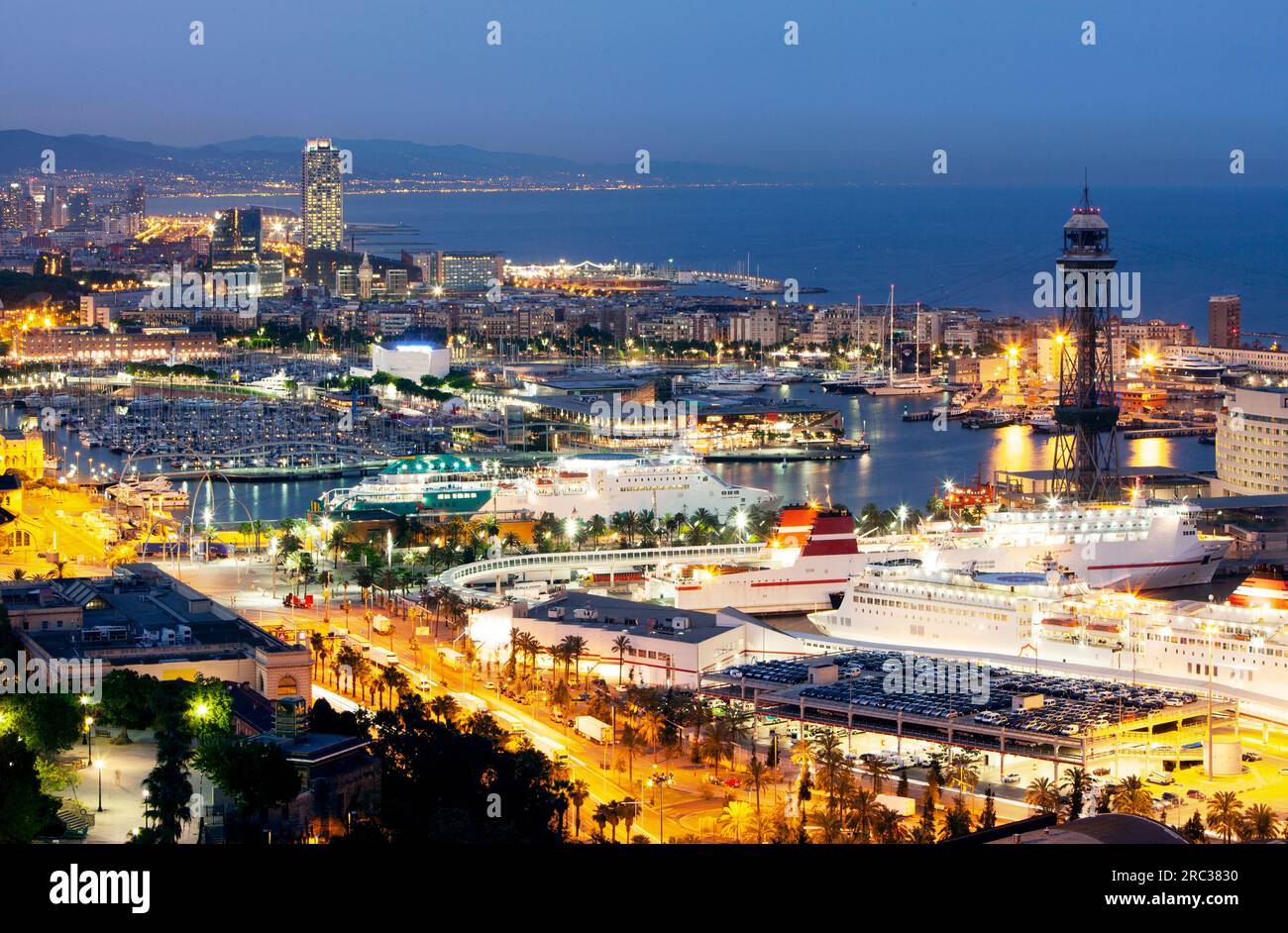 Aerial view of the skyline of Barcelona illuminated at dusk Stock Photo ...