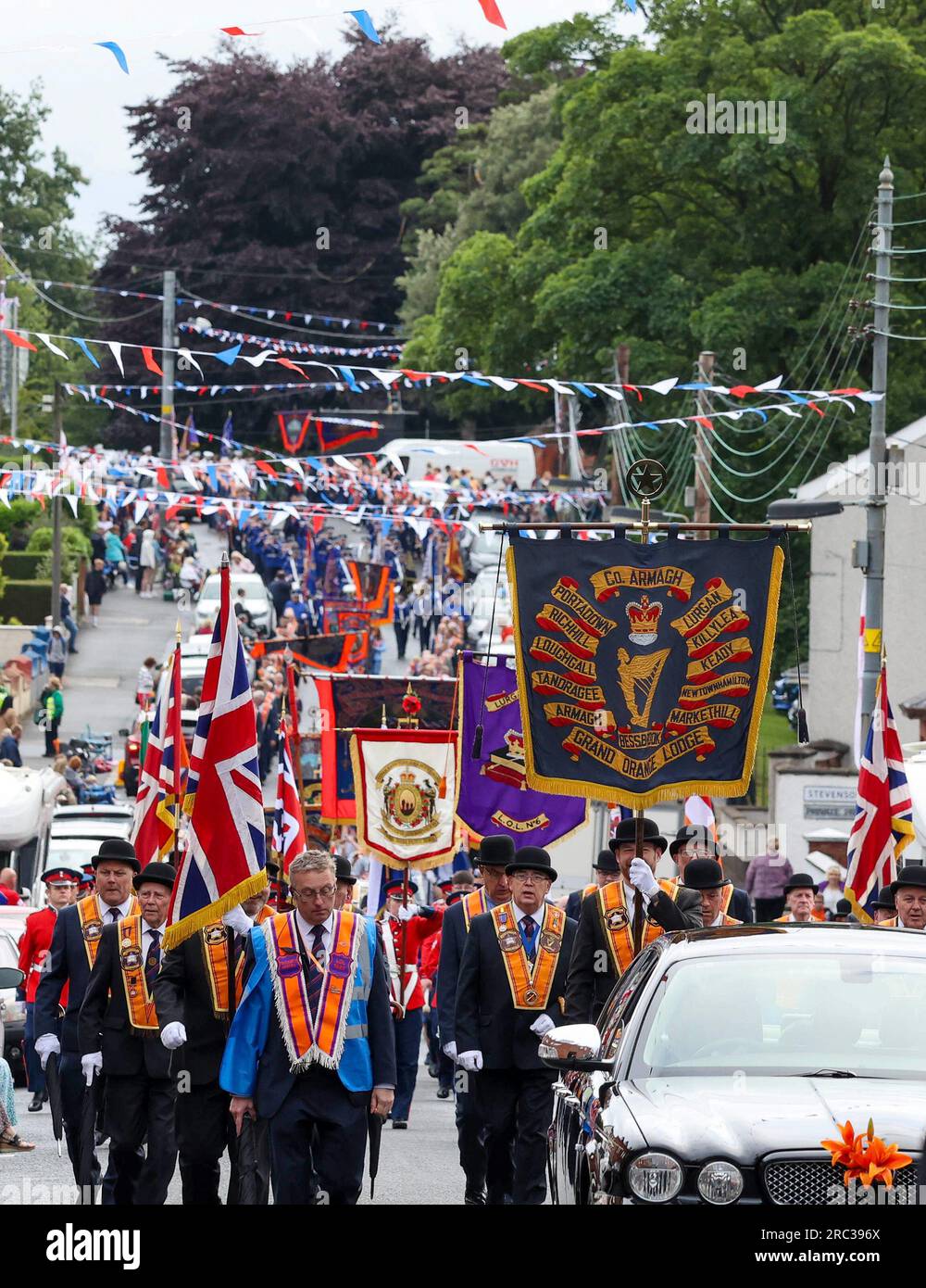 Lurgan, County Armagh, Northern Ireland.12 Jul 2023. The Twelfth of July is marked by Orange Order parades across Northern Ireland. Lurgan District left their headquarters at Brownlow House before parading up the town to the war memorial ahead of the main County Armagh demonstration being held in the town this year.The parades across Northern Ireland mark the victory of William of Orange over James at the Battle of the Boyne in 1690. Credit: CAZIMB/Alamy Live News. Stock Photo