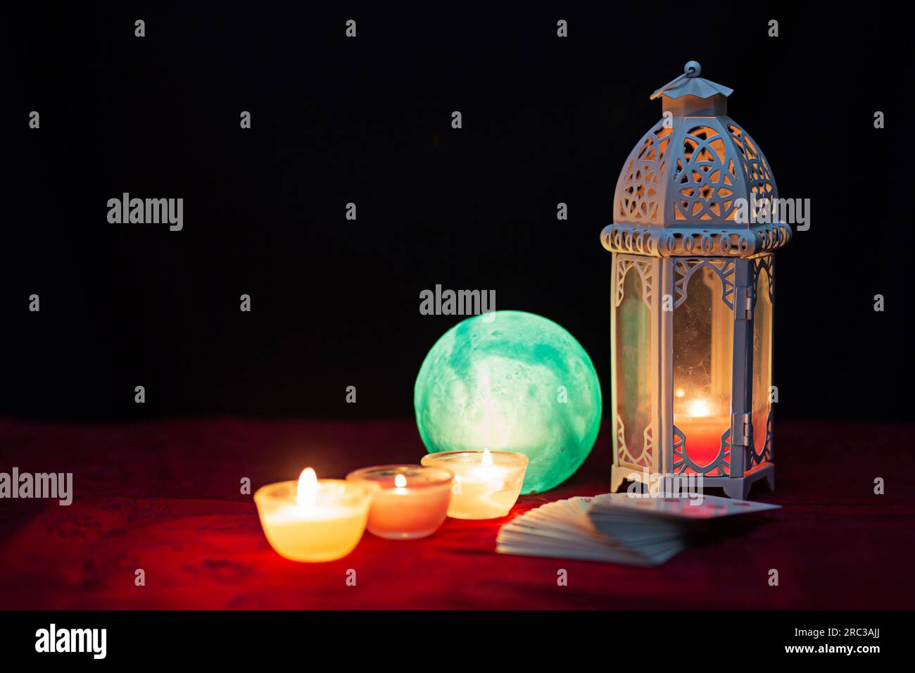 Crystal ball, deck of cards and candlelight on table. Mystery concept. Magic art. Stock Photo