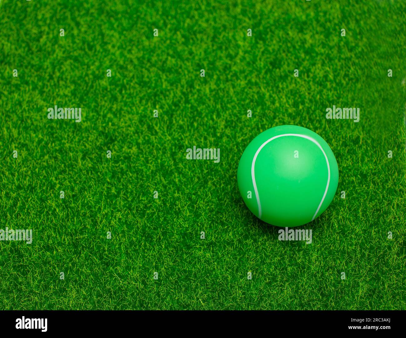 tennis ball set on soft background green grass Stock Photo - Alamy