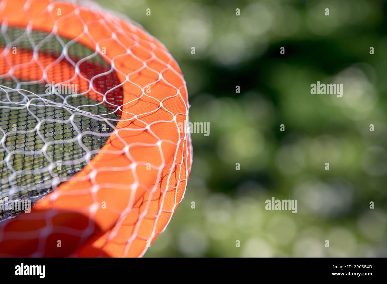 Detail image of tennis rackets on green background and quite blurred ...