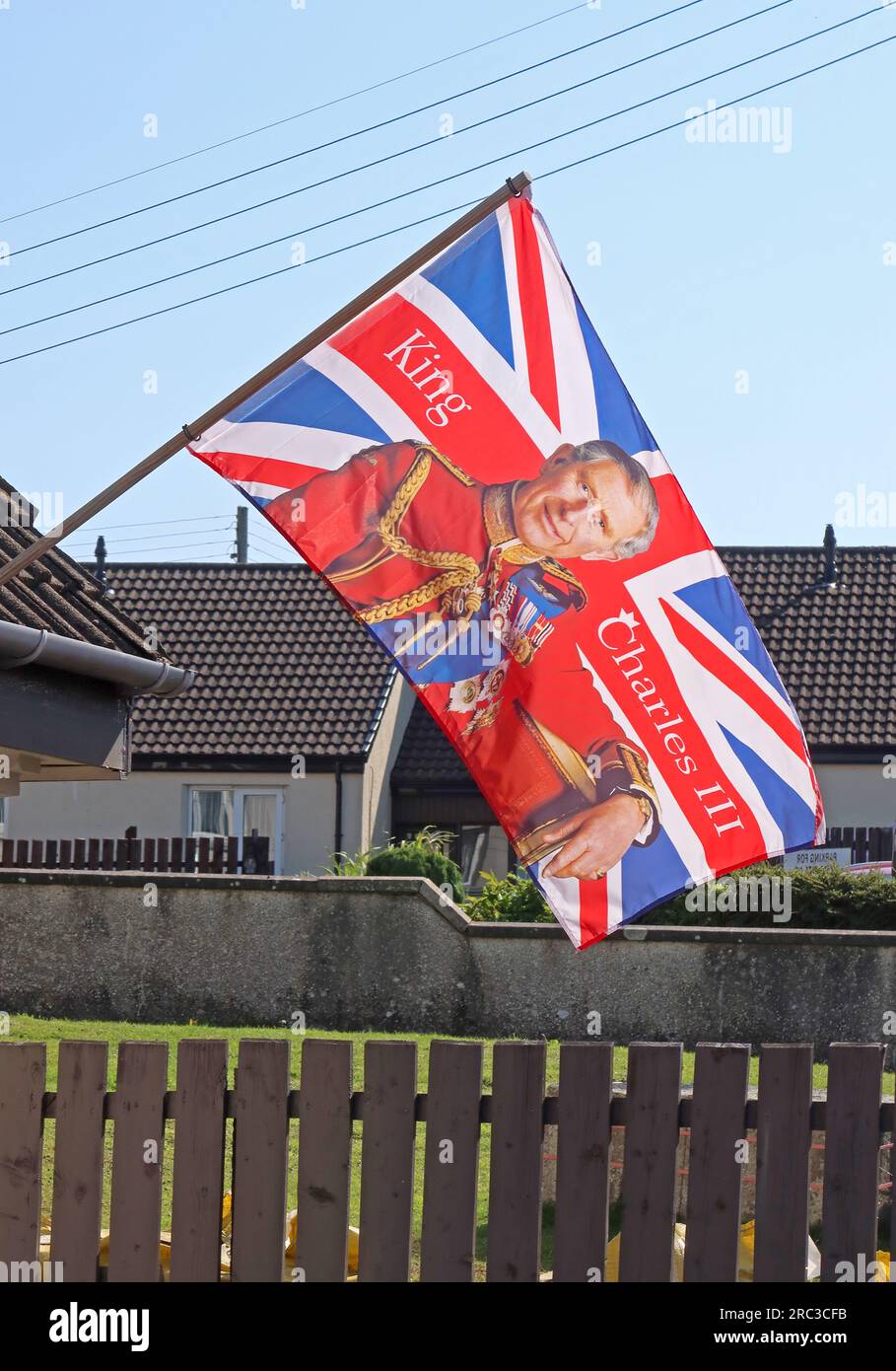 King Charles III coronation union flag, flying at house at Bridge St, Bushmills, County Antrim, Northern Ireland, UK, BT57 8QH Stock Photo