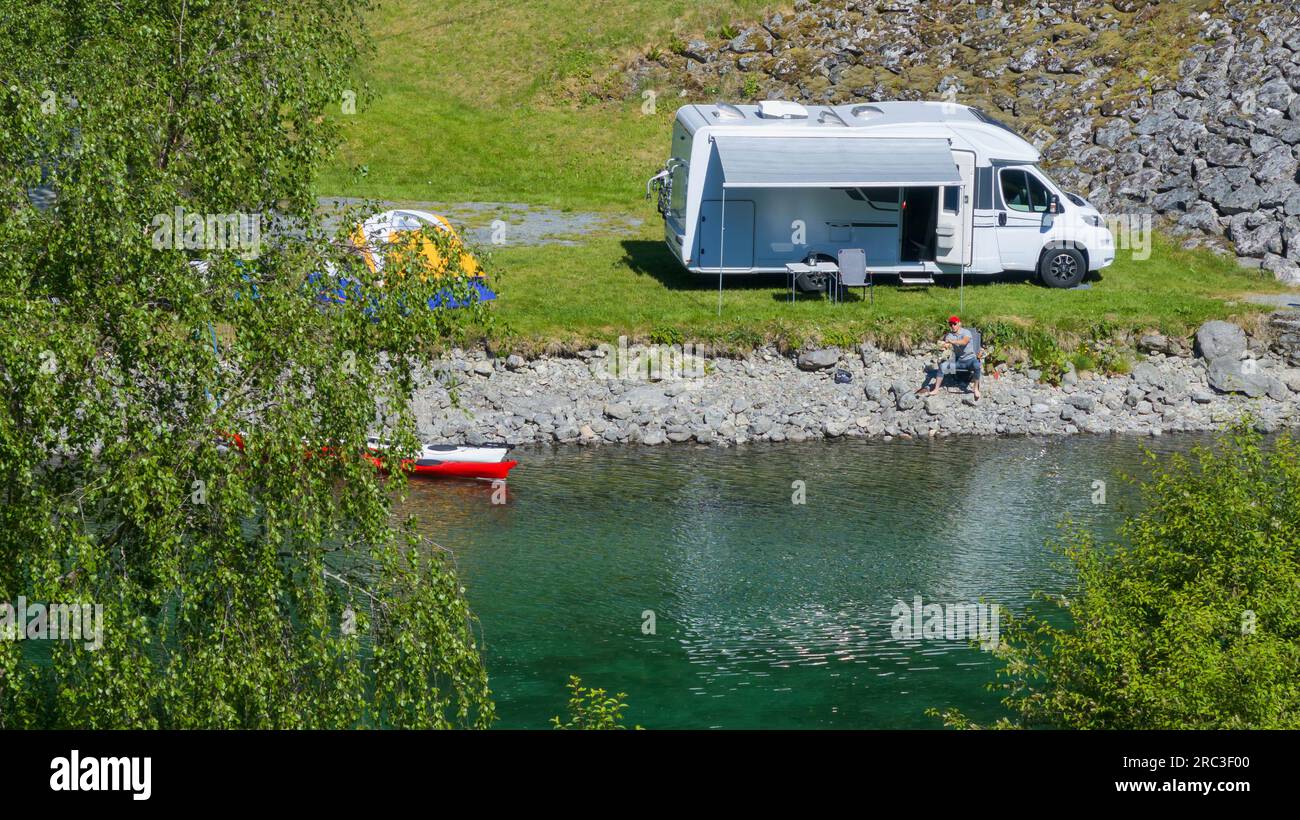 Riverfront RV Camper Van Camping with Tent and Kayaks in the Scenic Norway Stock Photo