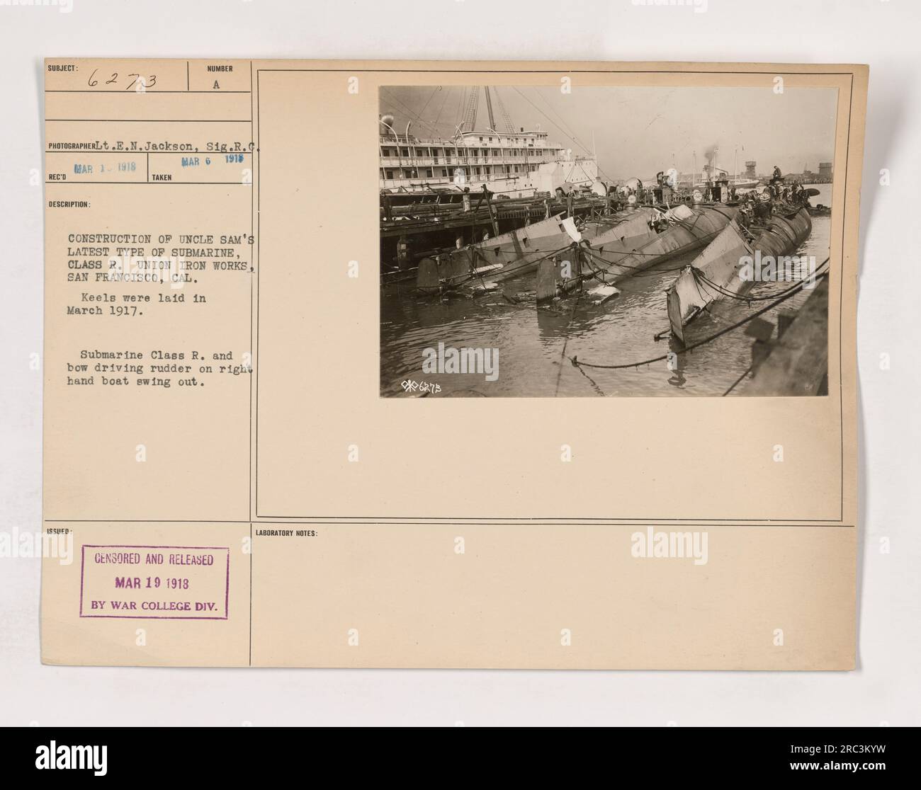 Image of construction taking place at the Union Iron Works in San Francisco. This photo showcases the building of the latest type of submarine for the United States, a Class R submarine. The keels were laid in March 1917, and the image shows the bow driving rudder on the right-hand boat swinging out. This information was censored and released by the War College Division laboratory on March 19, 1918. Stock Photo