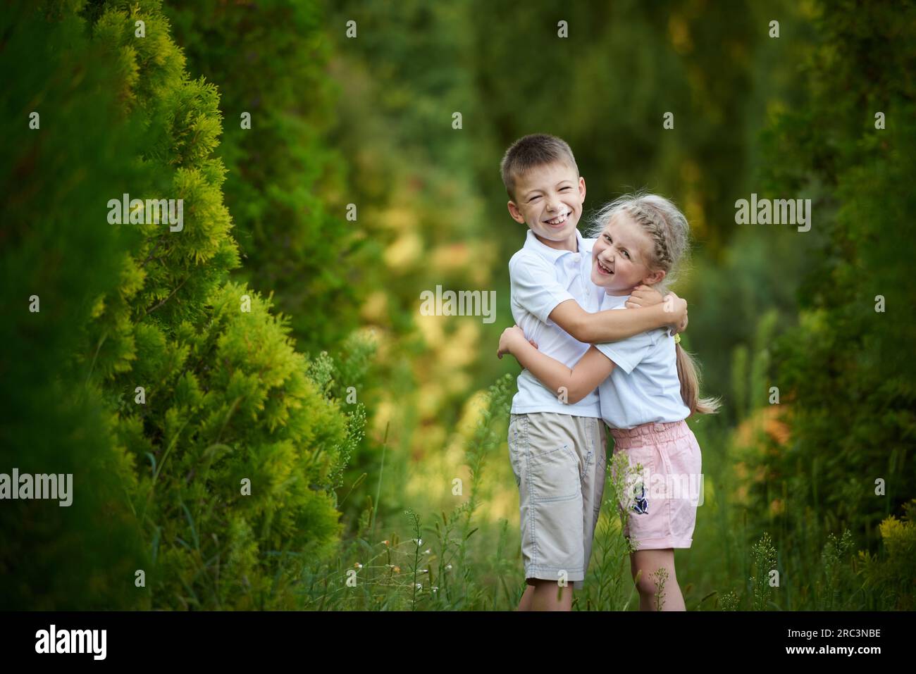 Little brother and sister hugging and happy together in the park Stock ...