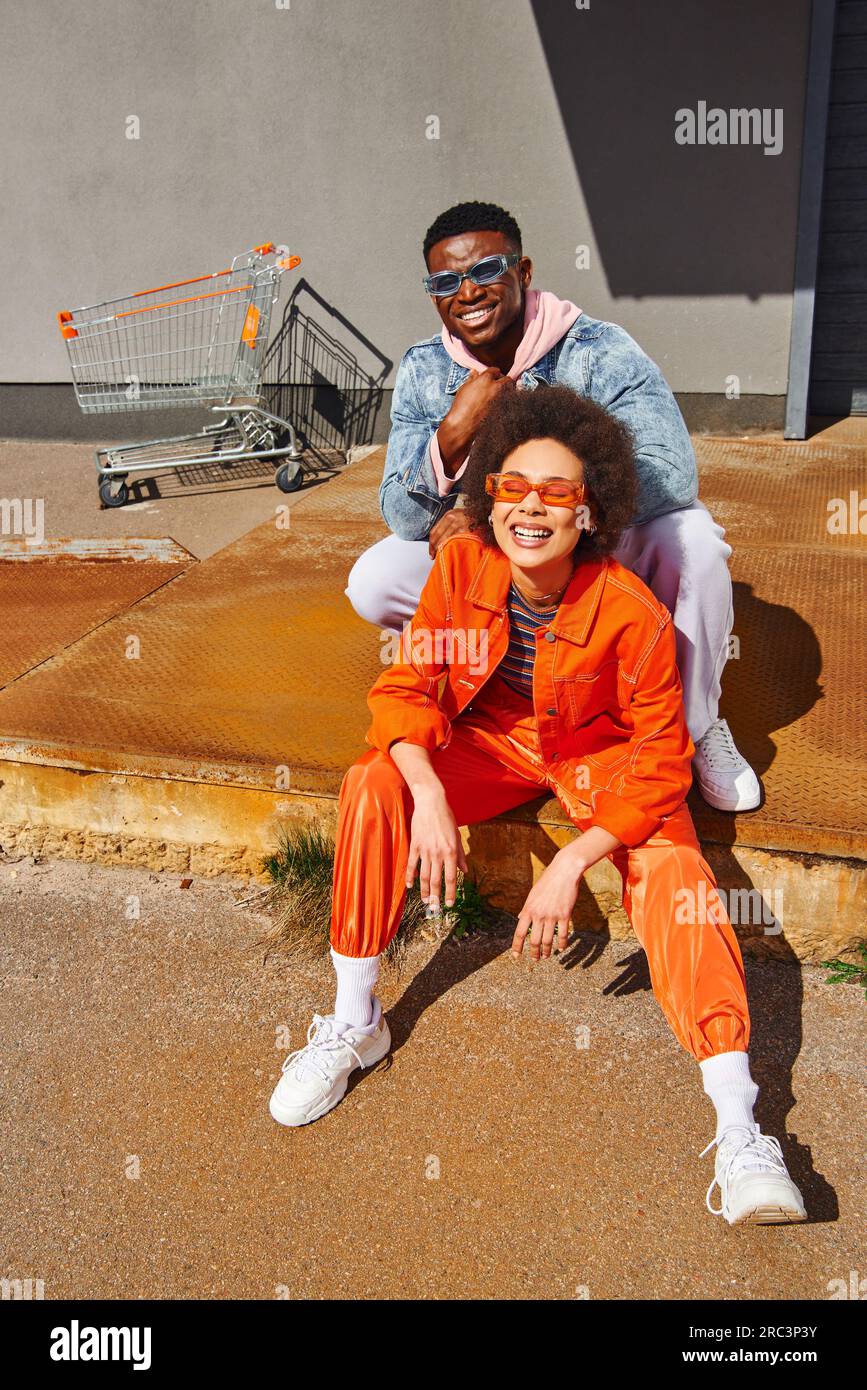 Full length of cheerful young african american woman in sunglasses and ...