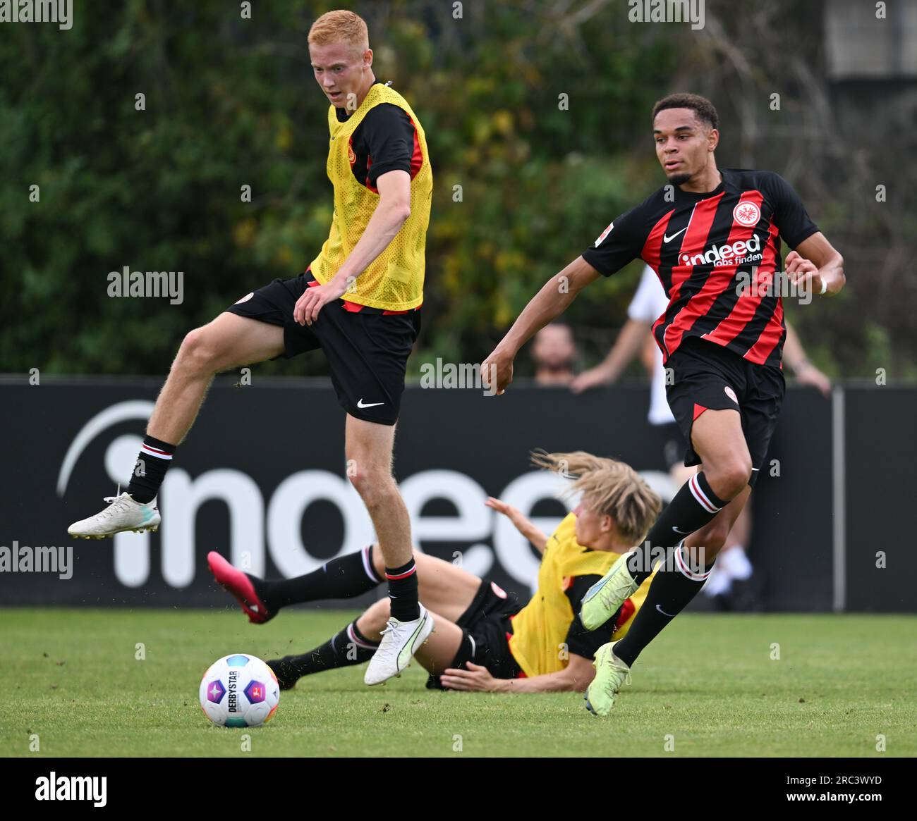 12 July 2023, Hesse, Frankfurt/Main: Newcomer Hugo Larsson (l) and Dario Gebuhr (r) battle for the ball with Jens Petter Hauge at Eintracht Frankfurt's official training kick-off at the stadium. Photo: Arne Dedert/dpa Stock Photo