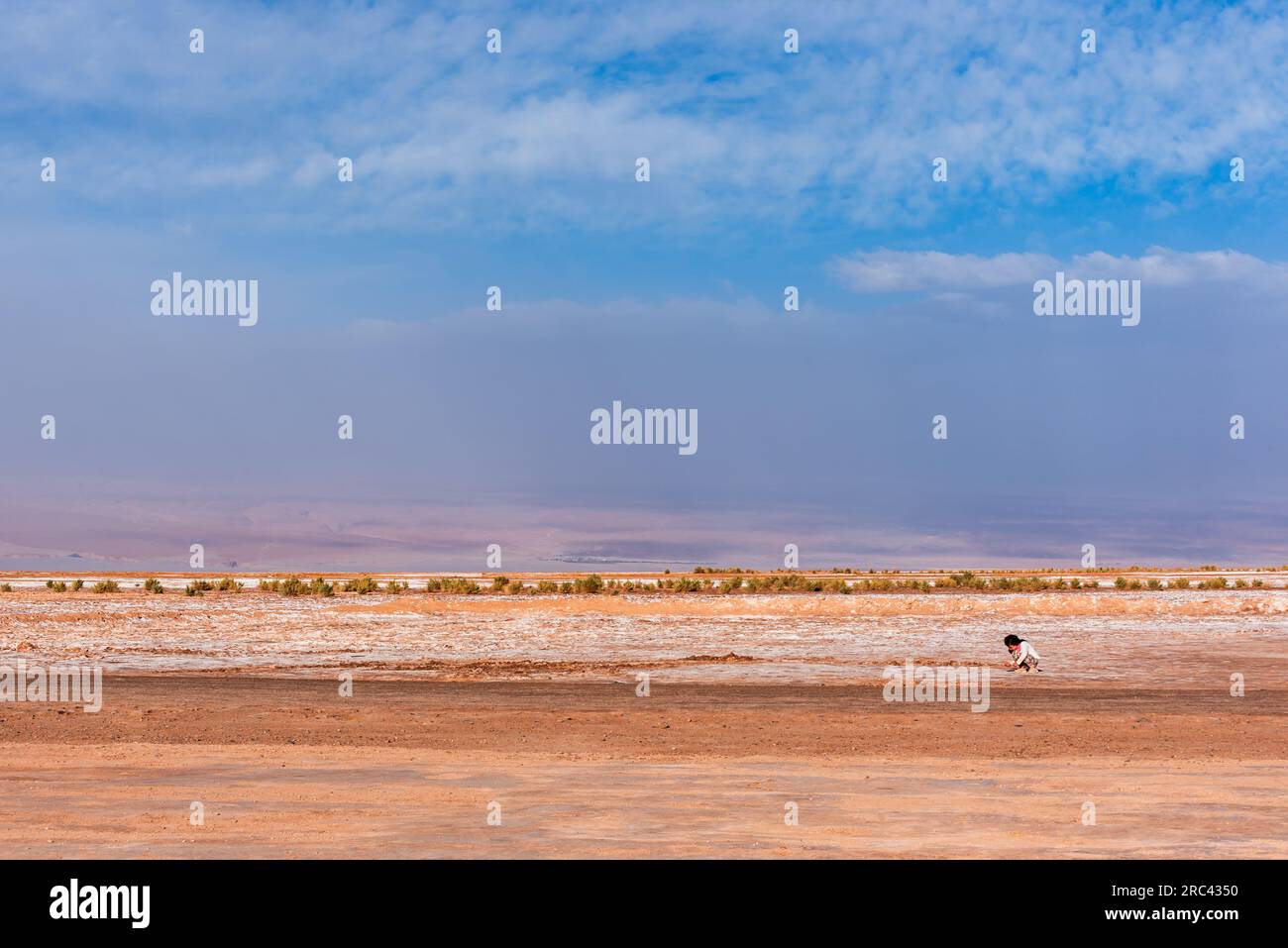 Lonely child playing alone in Atacama desert Stock Photo