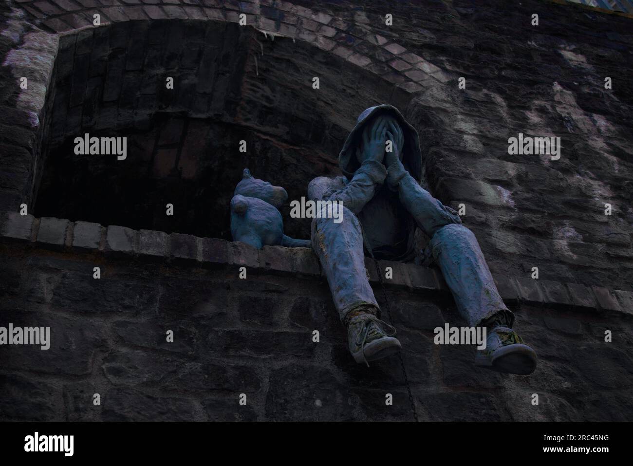 A sculpture of a man with a bear by his side in Clifton area, Bristol