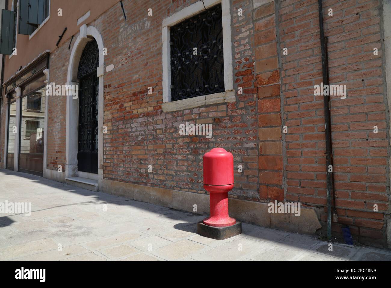 Fire hydrant in Venice, Italy. Fire safety infrastructure red