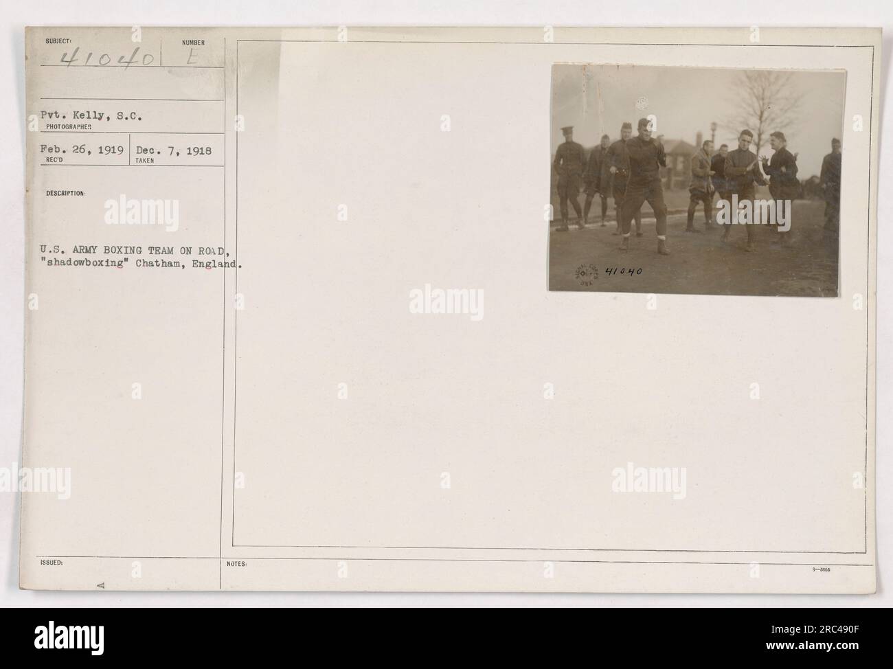 A photograph taken by Pvt. Kelly on February 26, 1919, documents the U.S. Army Boxing Team during their stay in Chatham, England. The image captures the team engaged in 'shadowboxing' as part of their training. This photograph is assigned the unique identification number 41040. Stock Photo