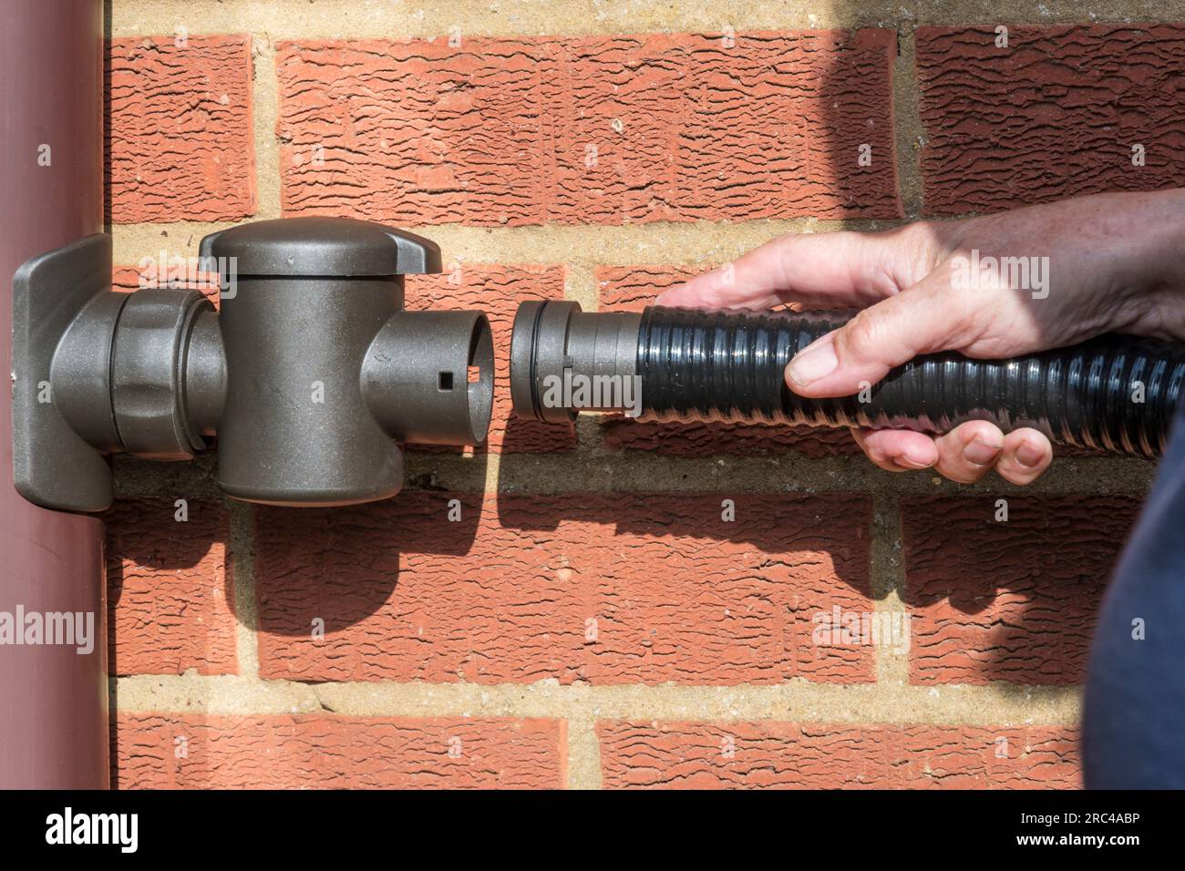 Fitting a hose from a water butt to a filter & diverter on a downpipe