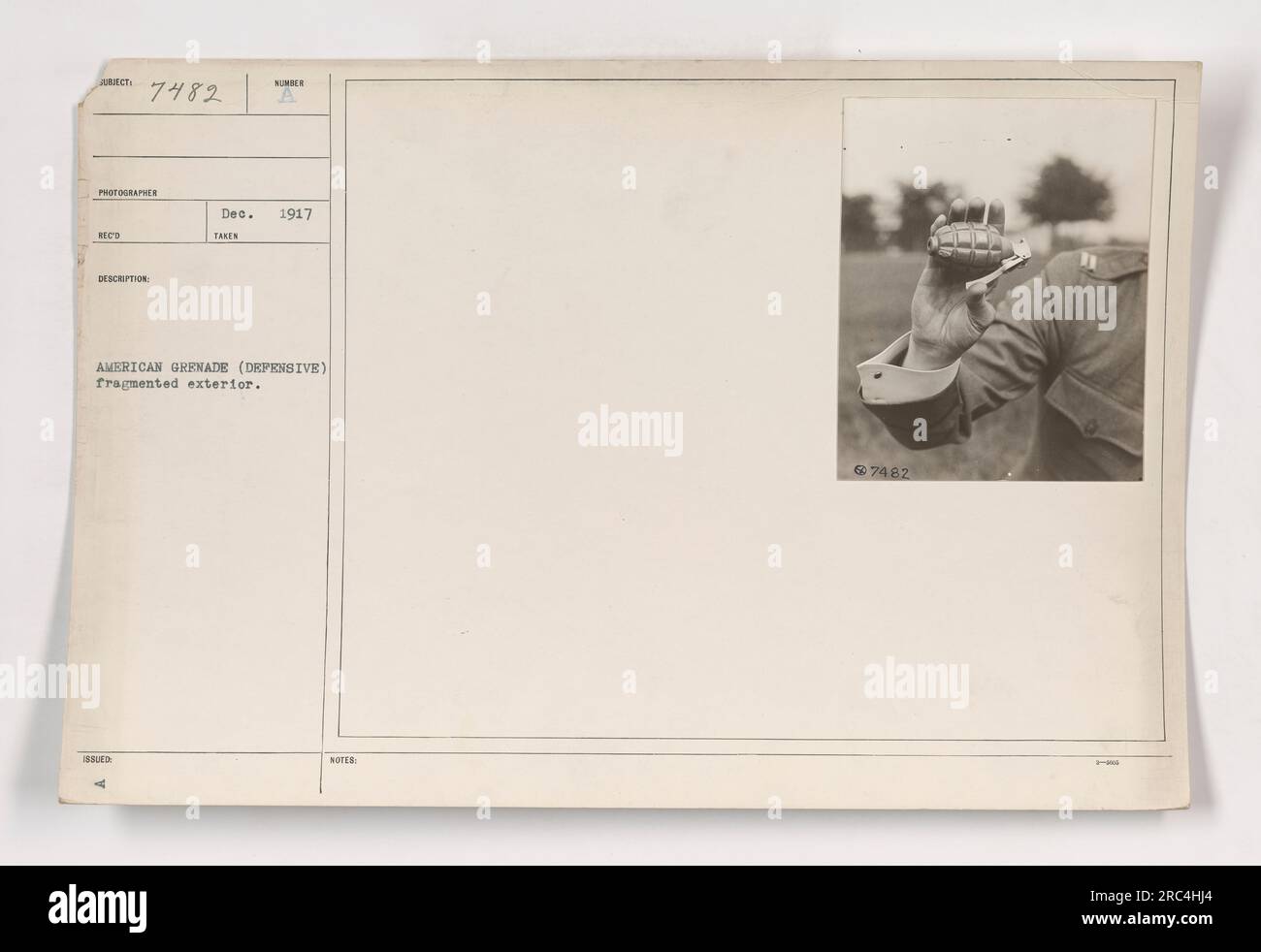 Soldier holding an American grenade (defensive) with a fragmented ...