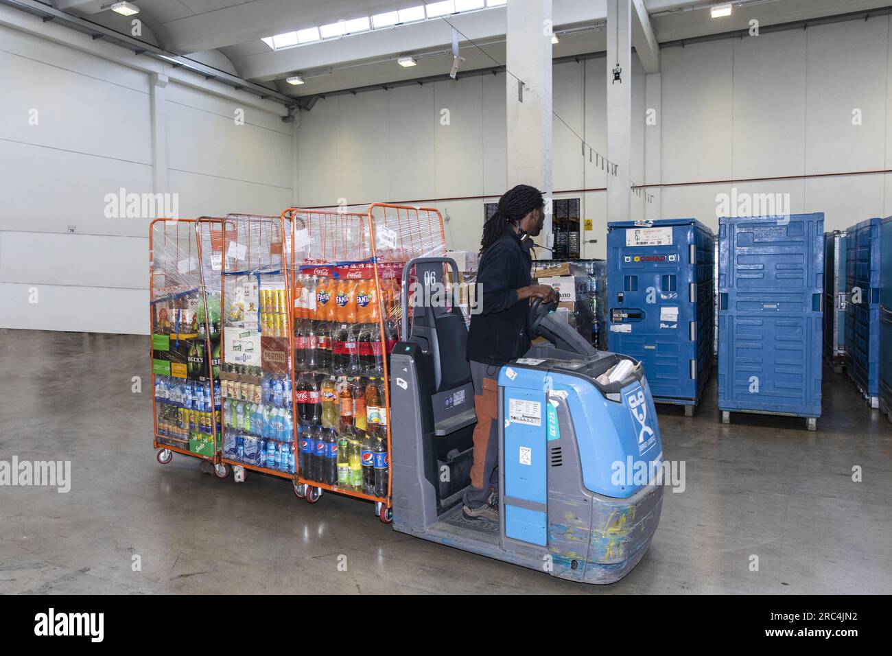 worker on the forklift that loads and distributes the food for the supermarkets Stock Photo