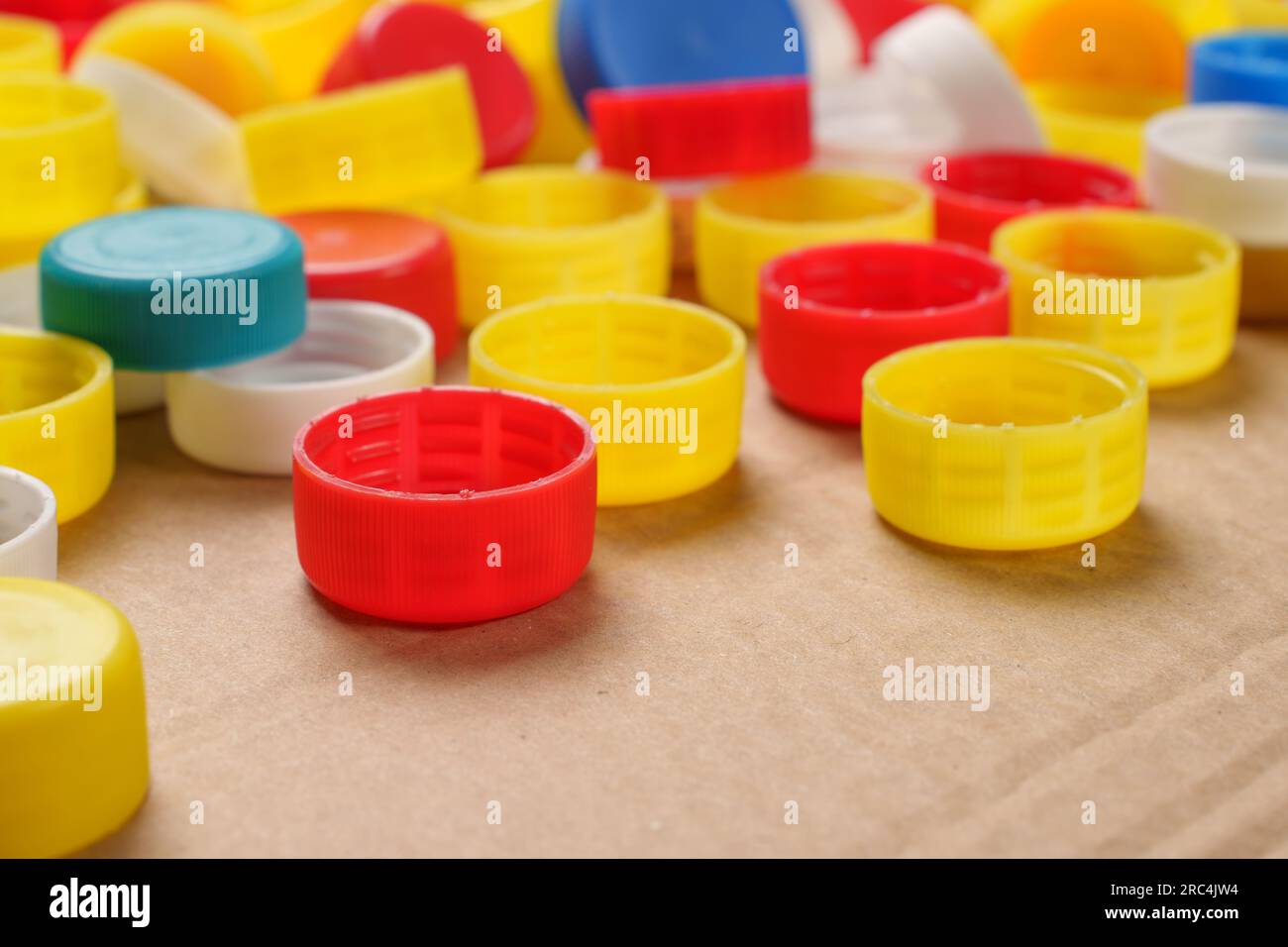 Colorful bottle caps background cardboard box. Used PET recycling