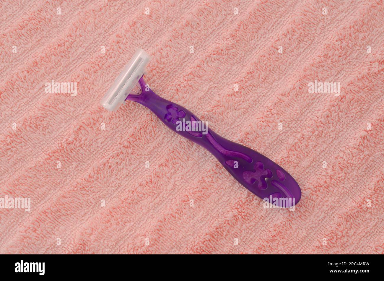 A delicate female razor resting on a smooth surface, ready to give a ...