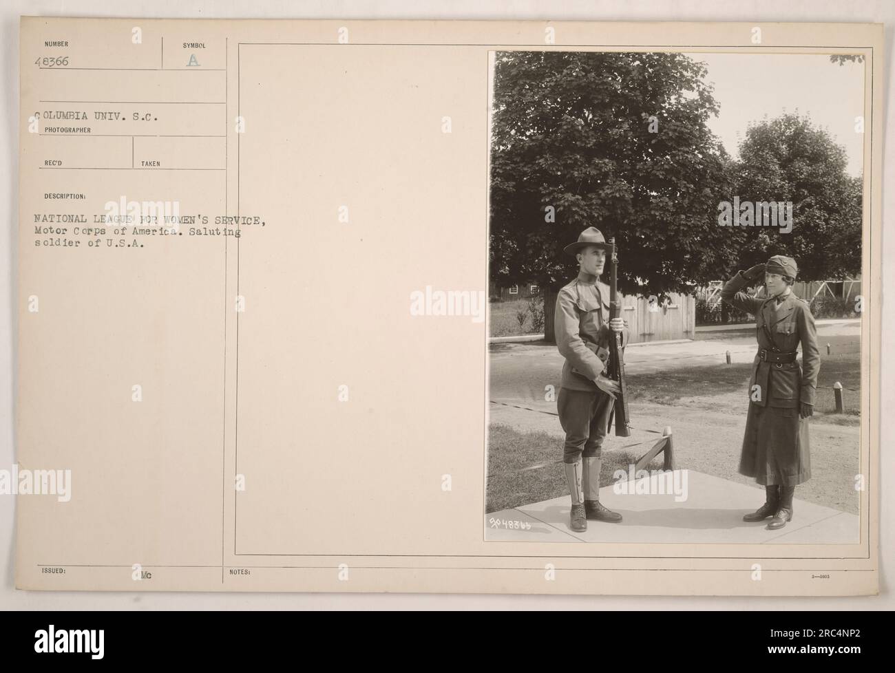 A member of the Motor Corps of America, affiliated with the National League for Women's Service, salutes a soldier of the U.S.A. The soldier's rifle number is 48366 and he represents Columbia University in South Carolina. This photograph was taken and issued by the National League for Women's Service, and bears the description 'SYMBO Mc NOTES 9048869.' Stock Photo