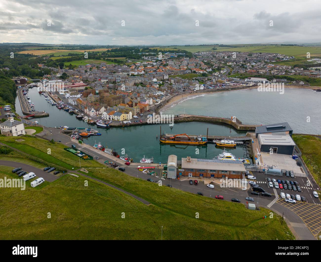 Aerial drone photo of the harbour town Eyemouth in Berwickshire, Scotland. It has a large harbour and a beach. Stock Photo
