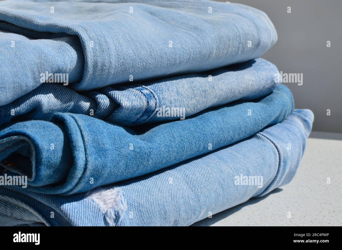 Seam lines highlighted on a blue jeans detail. Texture and style for