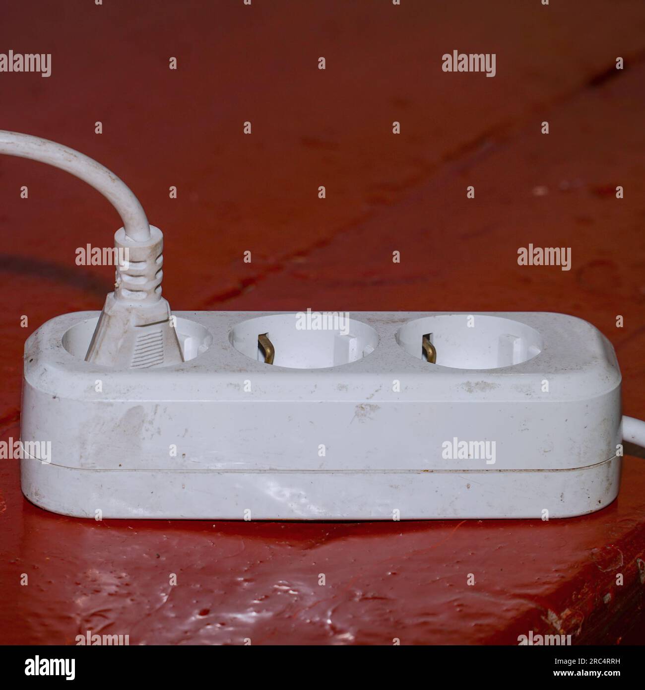 Old dirty extension cord on dirty parquet Stock Photo Alamy