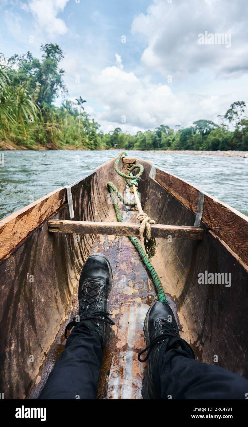 Traditional wooden boat with rope tied from bow to wooden plank riding ...