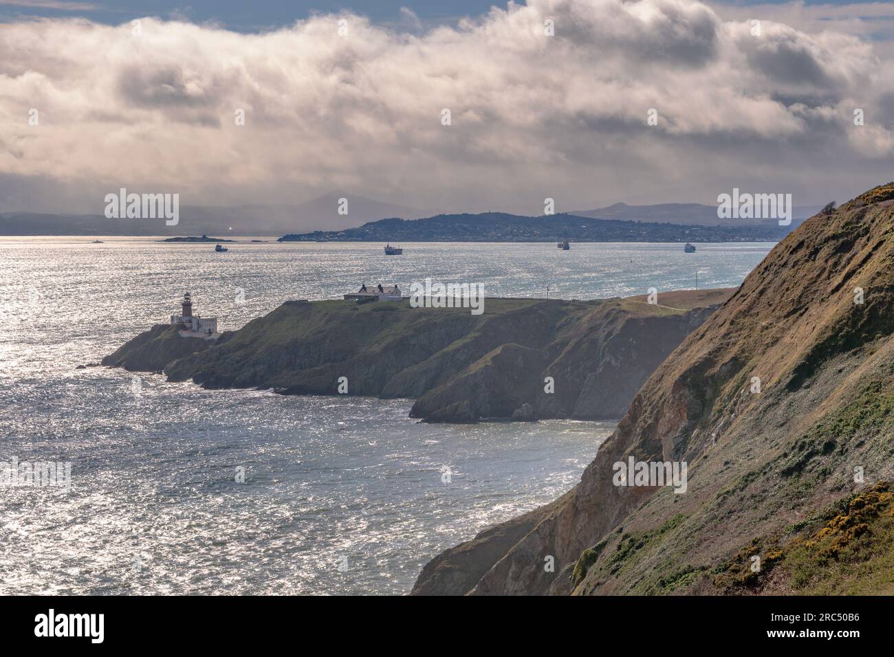 Howth, Ireland,  13th. March, 2023: Howth Lighthouse with ships in Dublin Bay in the background Stock Photo