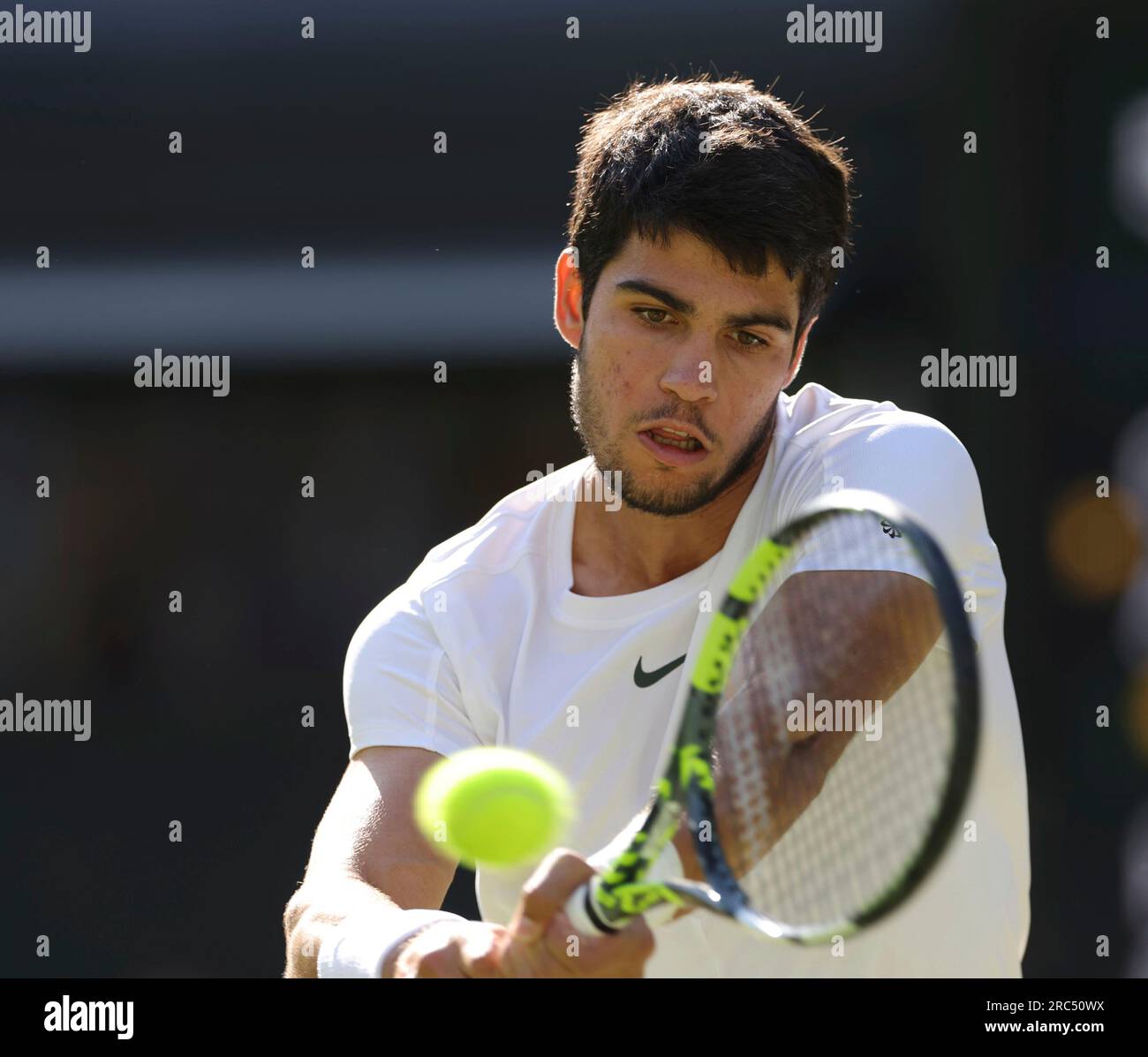 Carlos Alcaraz of Spain hits a ball during the Gentlemen's Singles  Quarter-finals match against Holger Rune of Denmark in the Championships,  Wimbledon at All England Lawn Tennis and Croquet Club in London,